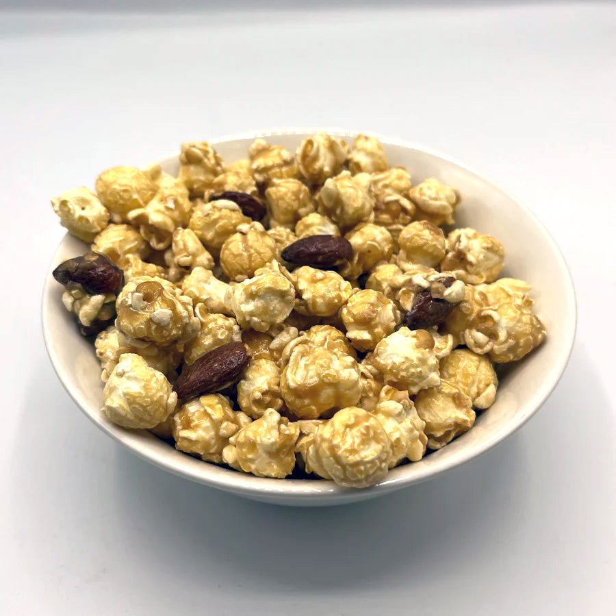 Almond Crunch Popcorn in an 8 oz bag from HR Poppin' Snacks, featuring golden popcorn with almond pieces.