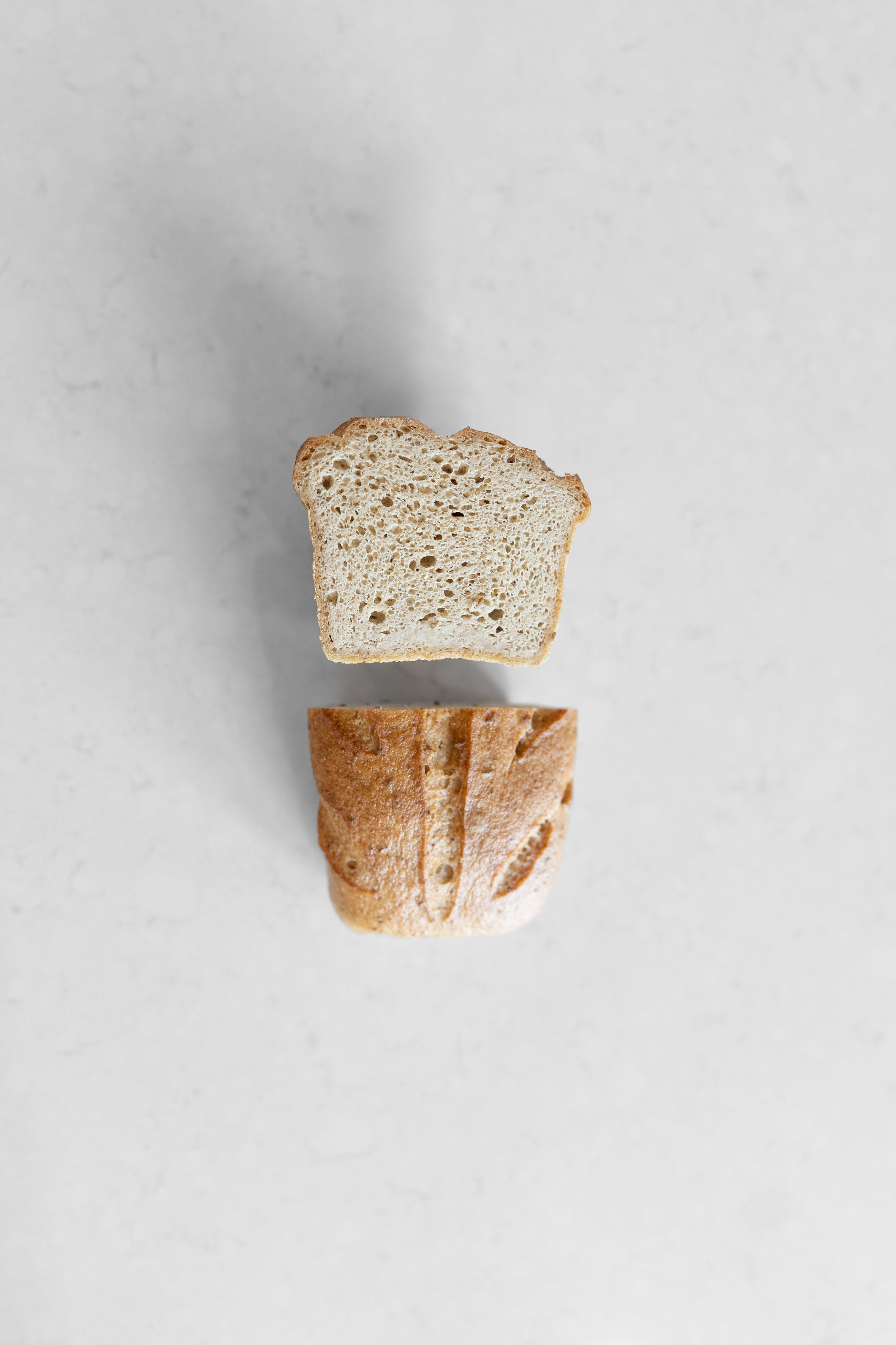 Gluten-free vegan Caraway Sourdough loaf from Heaven Gluten Free Bakery, sliced with visible caraway seeds on top.