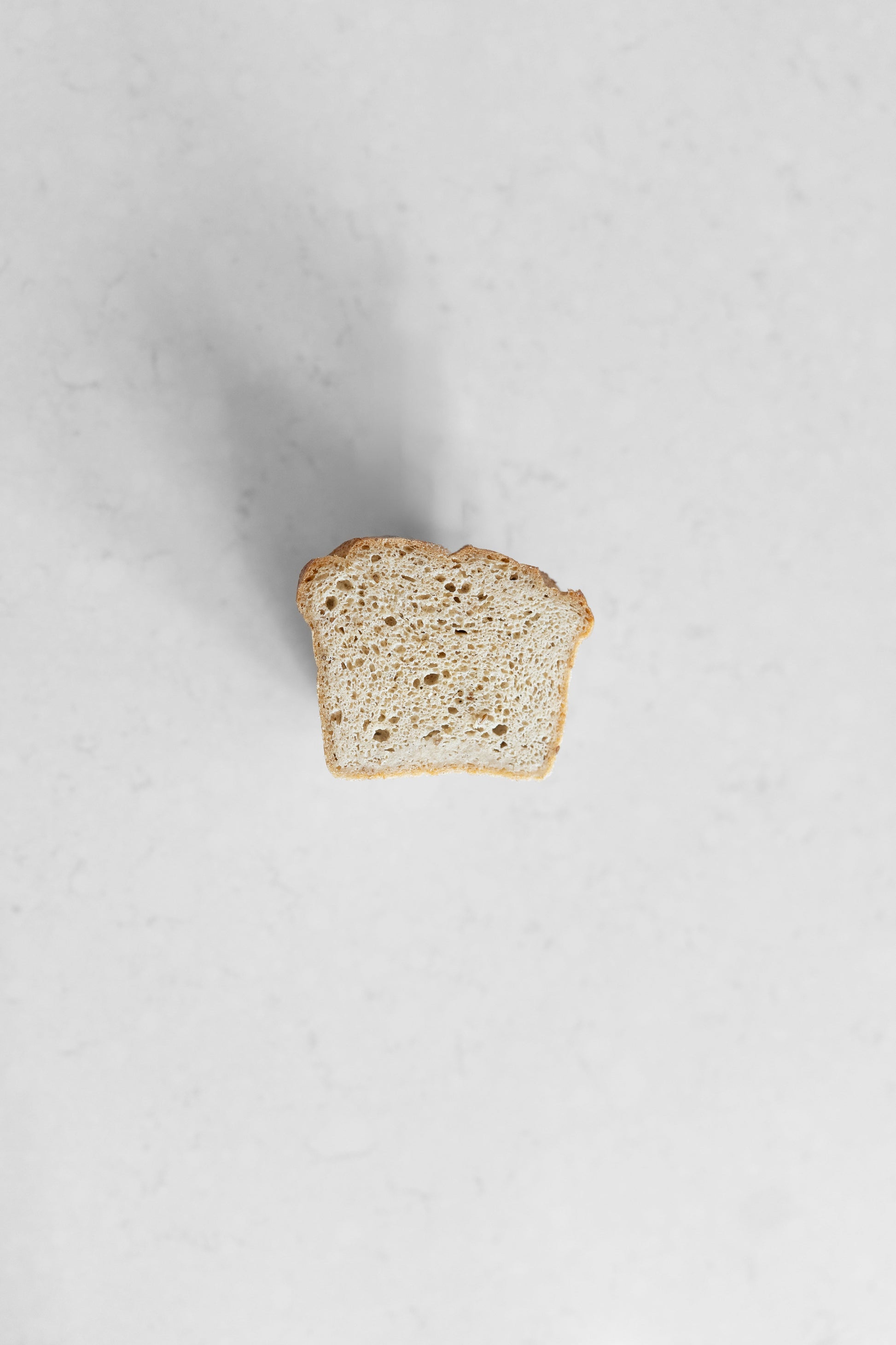 Vegan gluten-free Caraway Sourdough loaf from Heaven Gluten Free Bakery, sliced with visible crust and interior texture.
