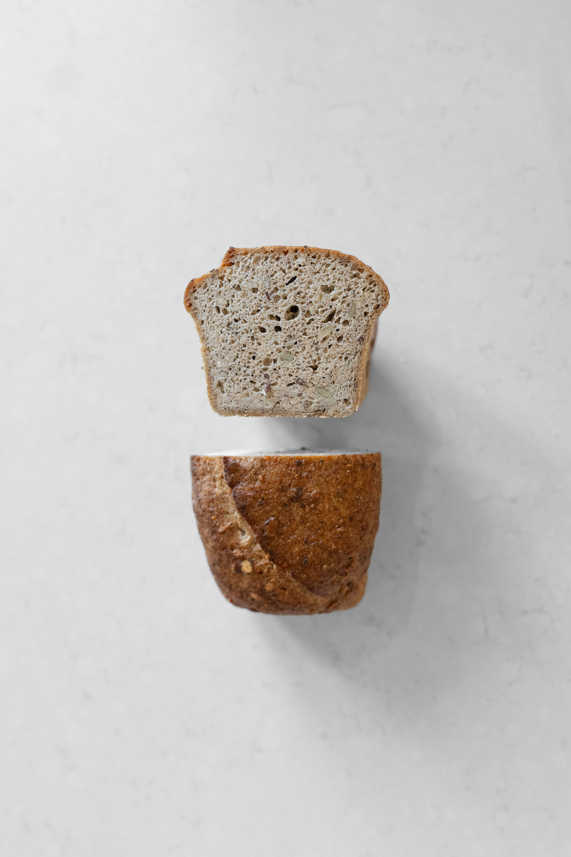 Heaven Gluten Free Bakery multi-seed sourdough vegan loaf with various seeds and a golden crust, gluten-free and plant-based.