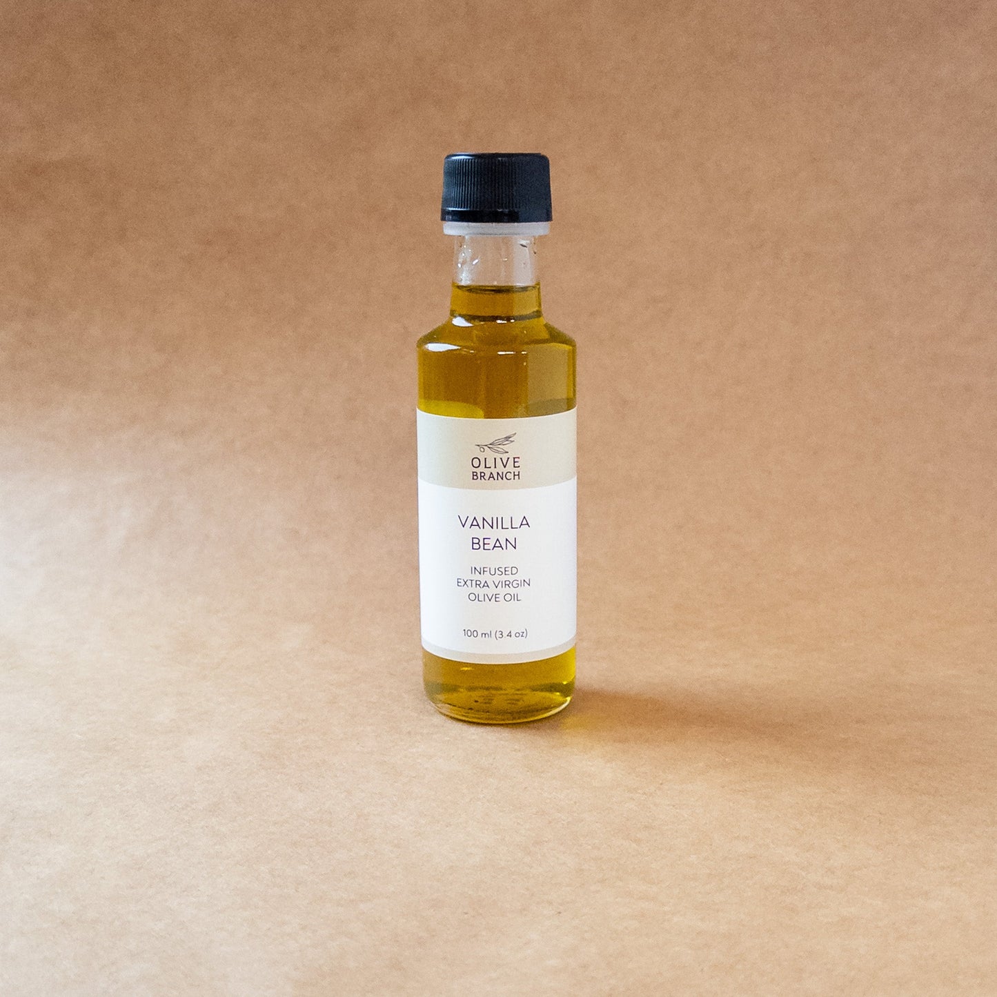 Bottle of Vanilla Bean Infused Extra Virgin Olive Oil from Olive Branch Oil & Spice, showcasing the infused olive oil with vanilla beans.