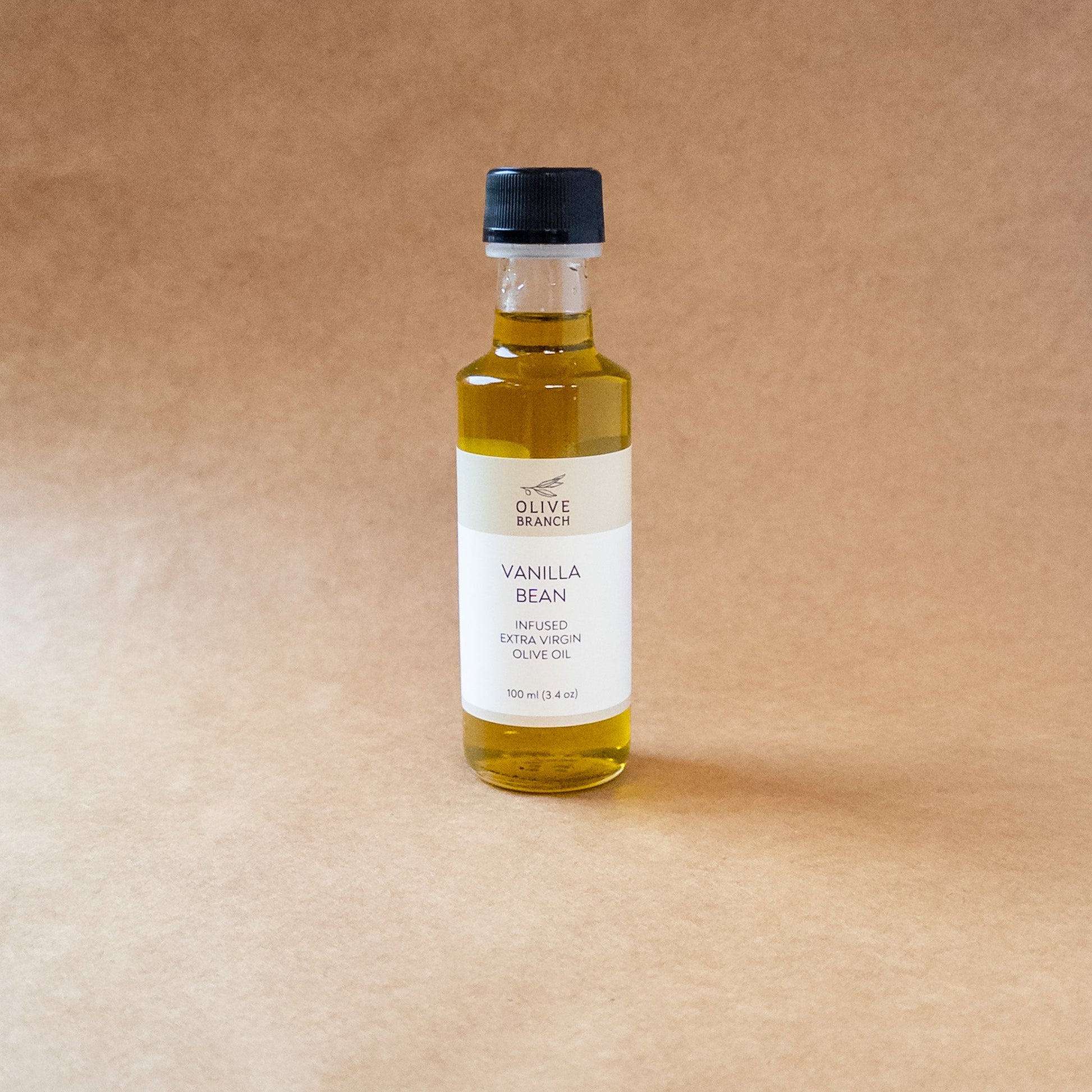 Bottle of Vanilla Bean Infused Extra Virgin Olive Oil from Olive Branch Oil & Spice, showcasing the infused olive oil with vanilla beans.