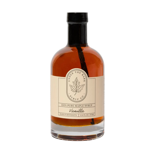 12oz bottle of Vanilla Maple Syrup by Under The Bark Syrup Co, showcasing a clear glass bottle with vanilla and maple syrup inside.