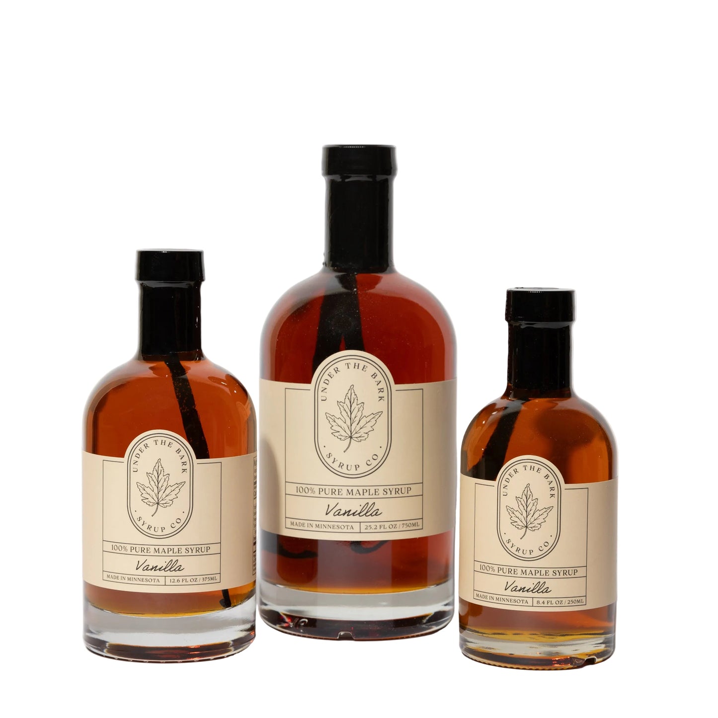 Vanilla Maple Syrup from Under The Bark Syrup Co, showcasing a clear glass bottle with vanilla and maple flavoring for food use.