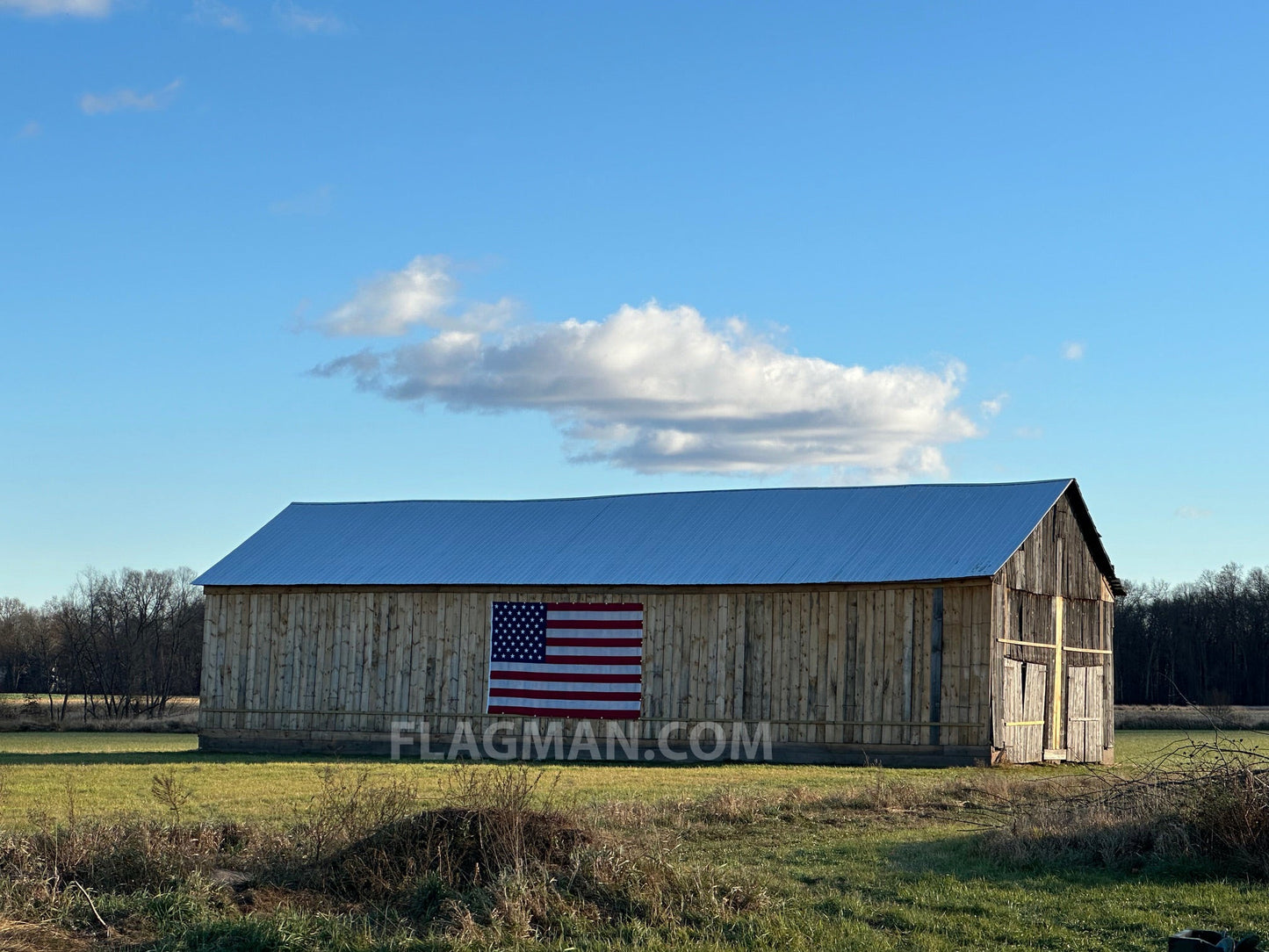 WallSafe™ polyester American flag by Flagman of America, wall-mounted flag with reinforced edge grommets and vibrant stars and stripes.
