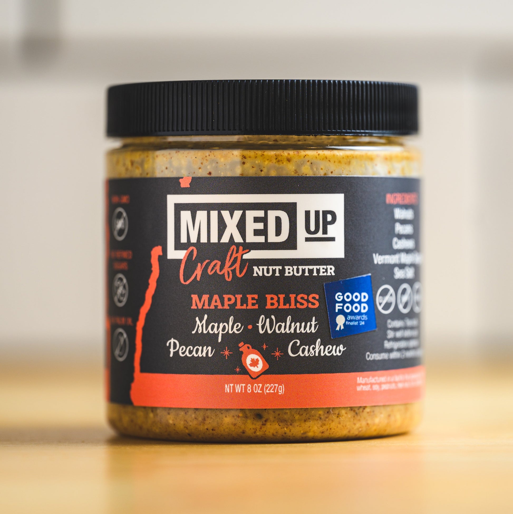 Creamy Maple Bliss nut butter from Mixed Up Foods with maple, walnut, and pecan nuts in an 8 oz jar.