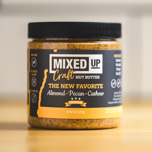 Creamy almond, pecan, and cashew nut butter in a jar from Mixed Up Foods, 8 oz, showcasing a smooth, nutty spread.