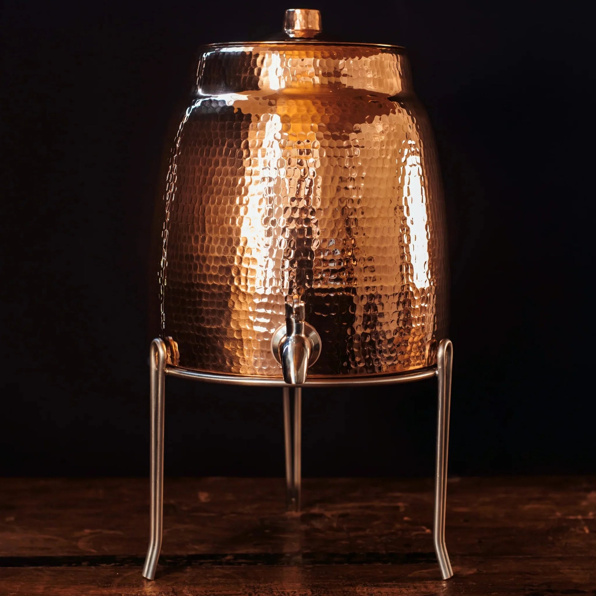 Stainless steel water dispenser stand by Sertodo, designed to hold water dispensers securely with a sleek, durable metal frame.