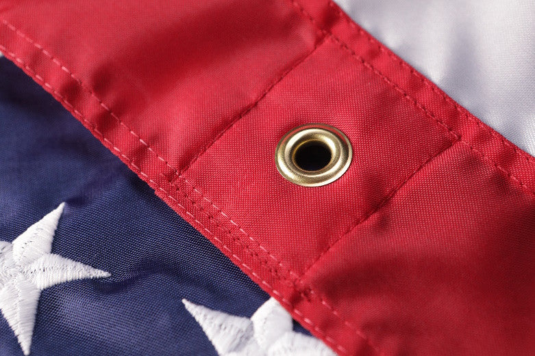 Close-up of WallSafe™ polyester American flag with reinforced edge grommets, wall-mounted display, made in the USA, by Flagman of America.