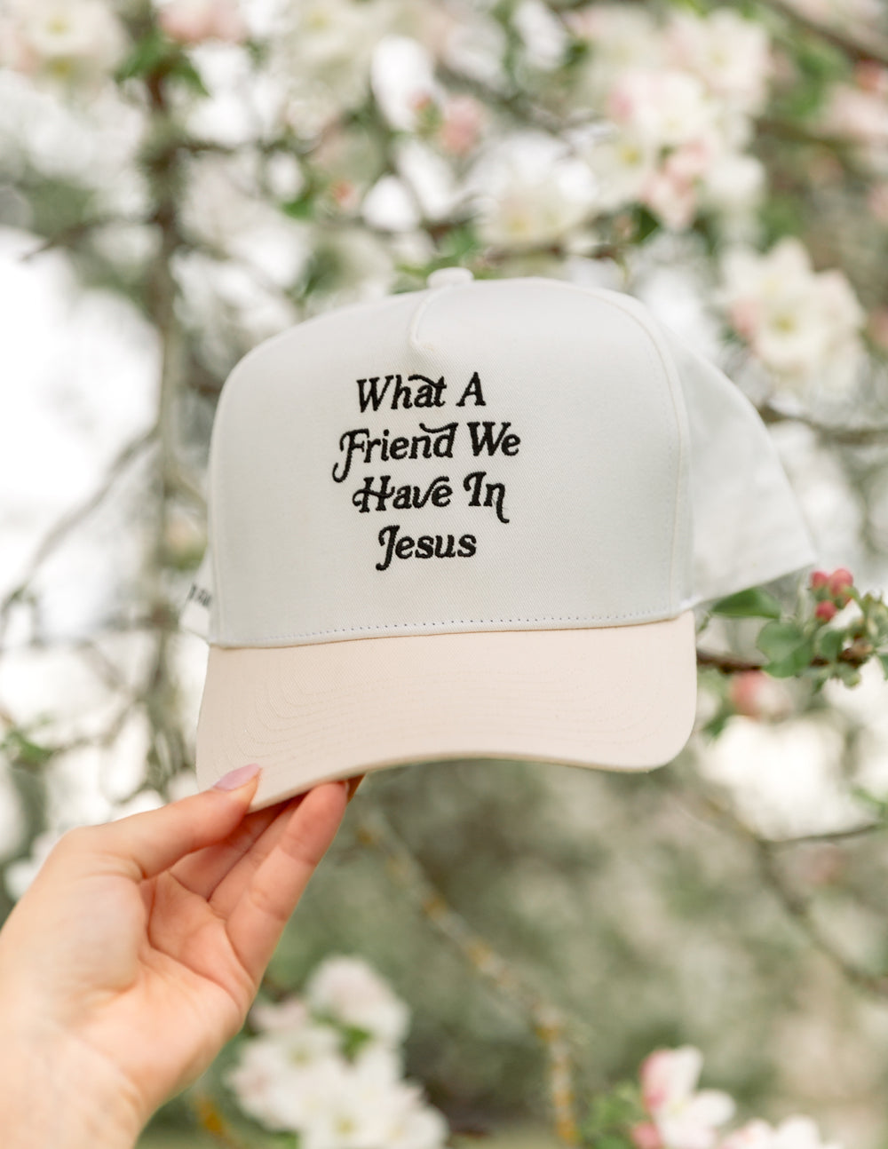 Elevated Faith trucker hat with "What a Friend in Jesus" embroidered front, casual design with mesh back for comfort.