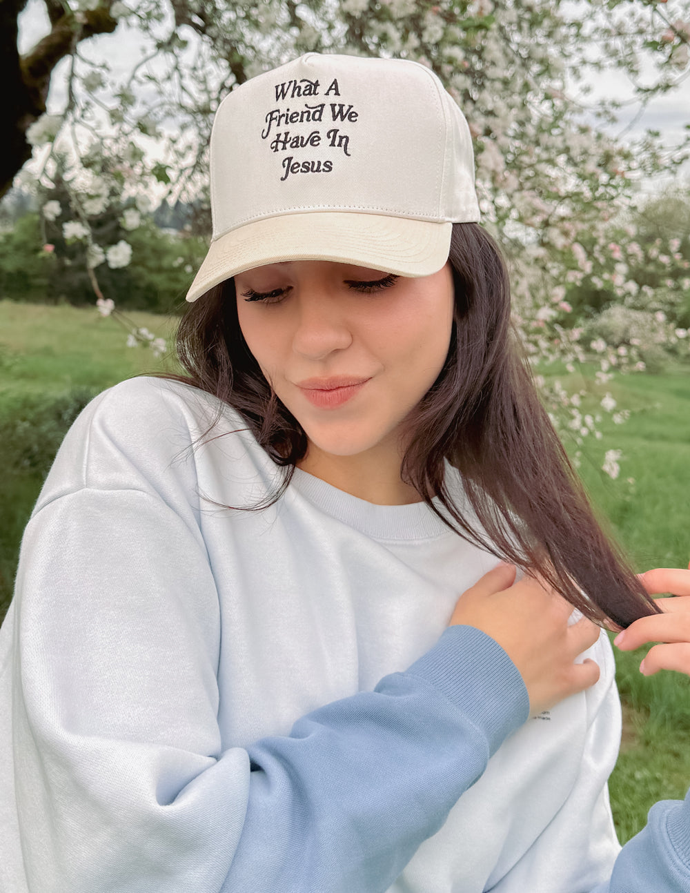 Elevated Faith trucker hat with "What a Friend in Jesus" embroidered design, casual adjustable cap for everyday wear.