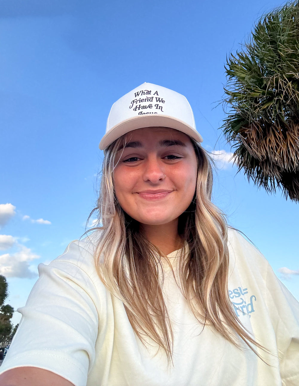 Elevated Faith trucker hat featuring the "What a Friend in Jesus" design, with a structured front and mesh back for casual wear.