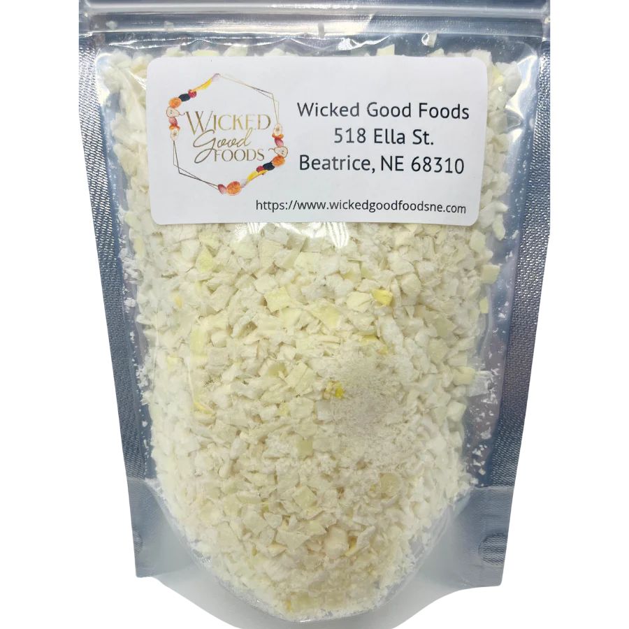 Freeze dried yellow onions from Wicked Good Foods in a 1 oz package, displayed in a clear bag with onion pieces visible inside.