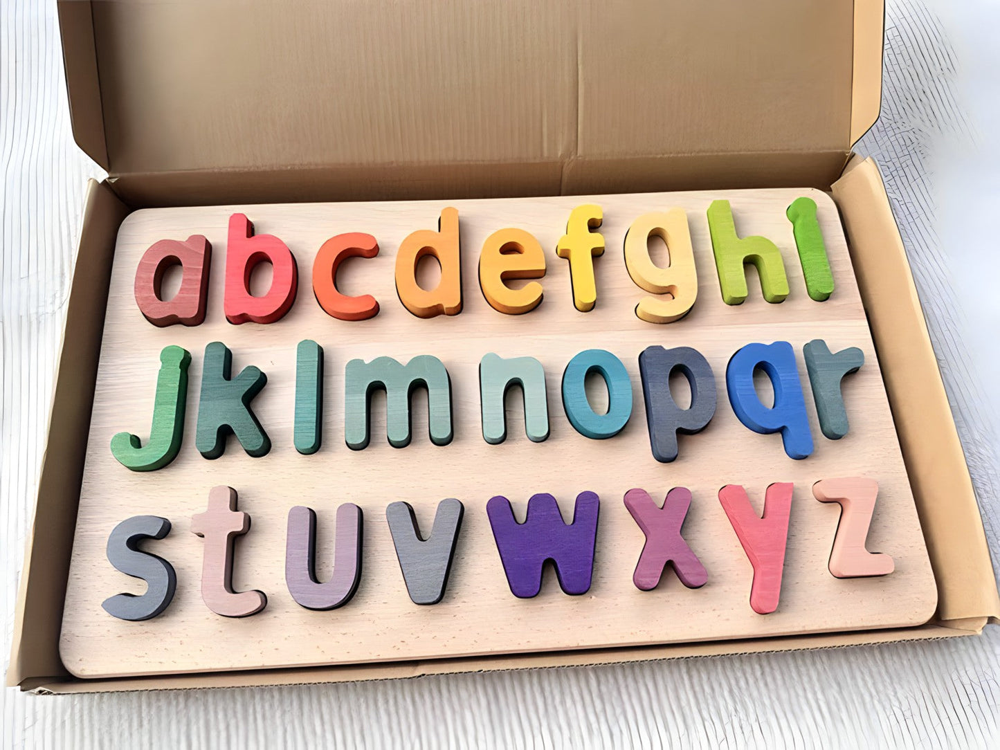 Colorful Montessori wooden alphabet puzzles by Petite Pioneers, featuring numbered pieces and bright educational design for kids.