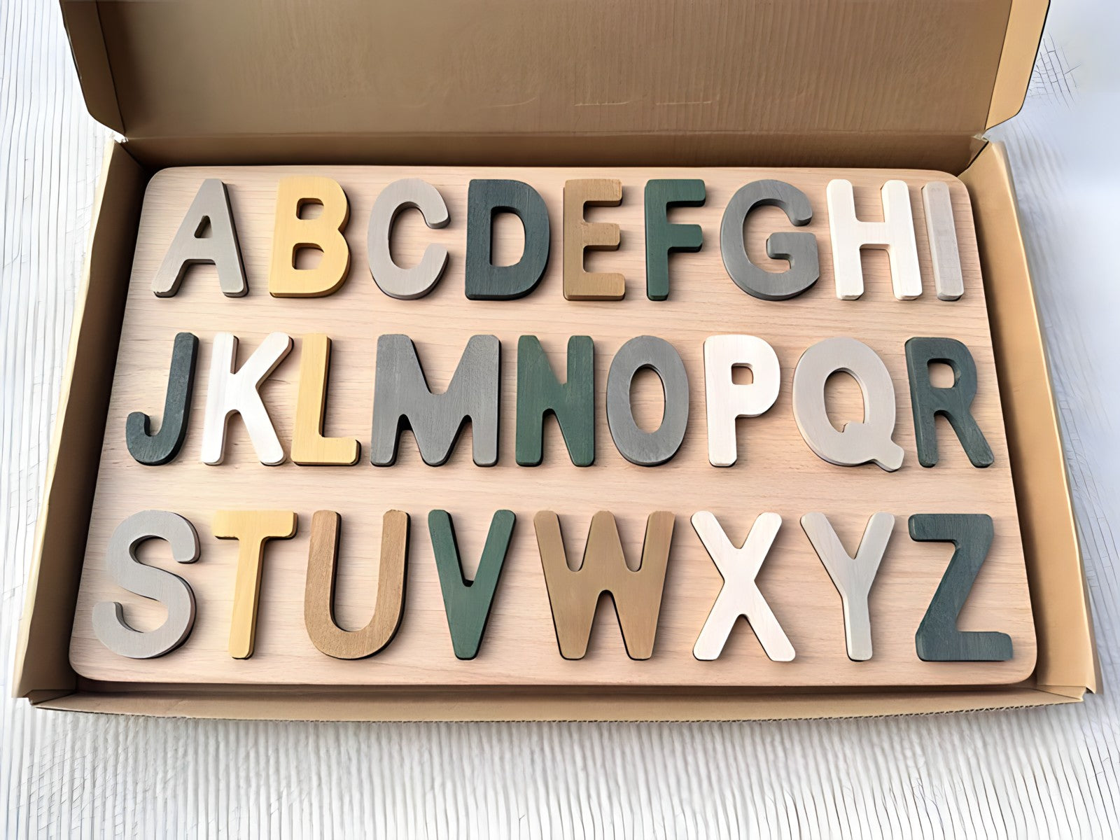 Colorful Montessori wooden puzzles by Petite Pioneers featuring alphabet and number pieces for early learning and development.