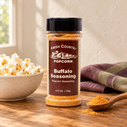 Buffalo popcorn seasoning from Amish Country Store on Amish Popcorn, featuring vibrant seasoning powder in a rustic container.