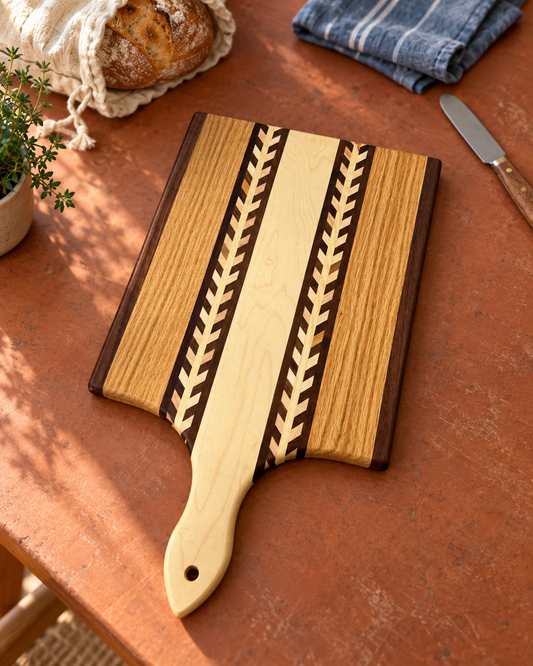 Amish handmade wheat inlay cutting board made of mixed hardwood, featuring a rustic paddle design for kitchen use.