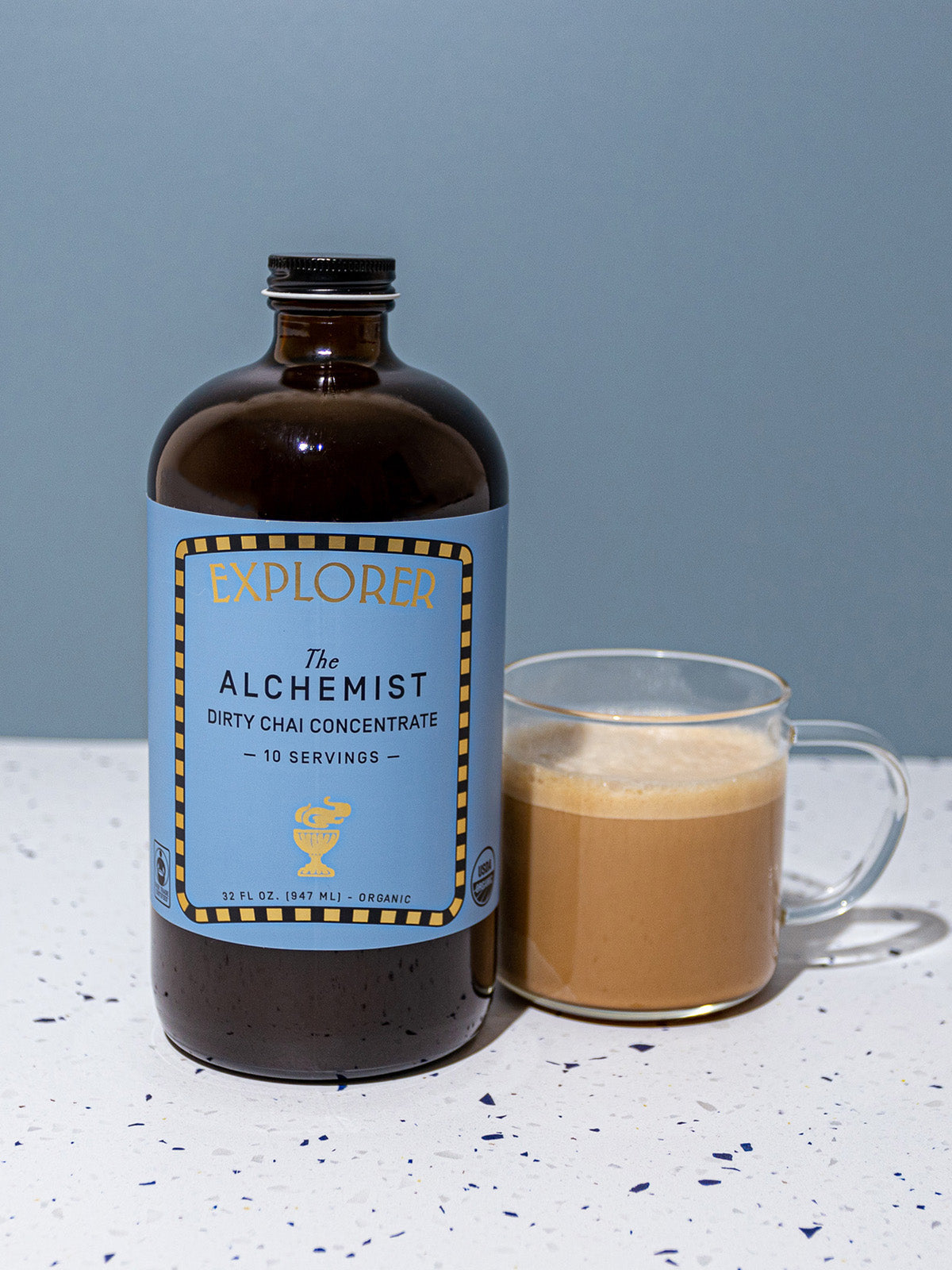 Alchemist-branded 32oz Explorer Cold Brew chai concentrate bottle, showcasing the tea and infusion product.
