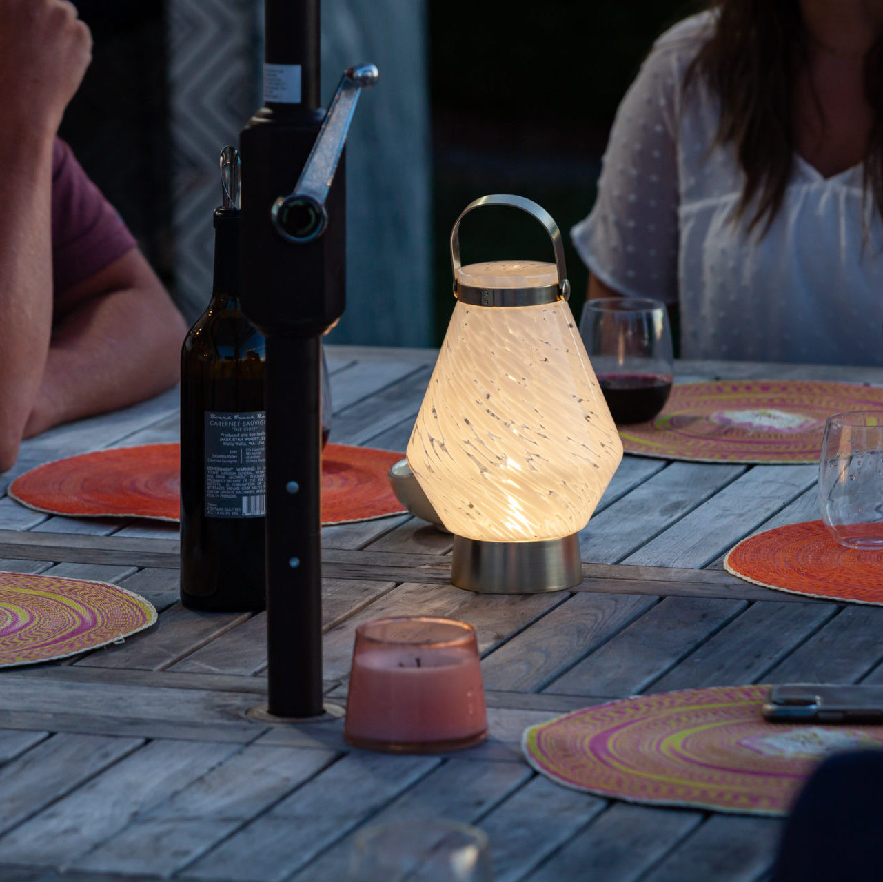 Allsop Home & Garden LightKeeper rechargeable glass LED lanterns with handles, illuminating with a warm glow.
