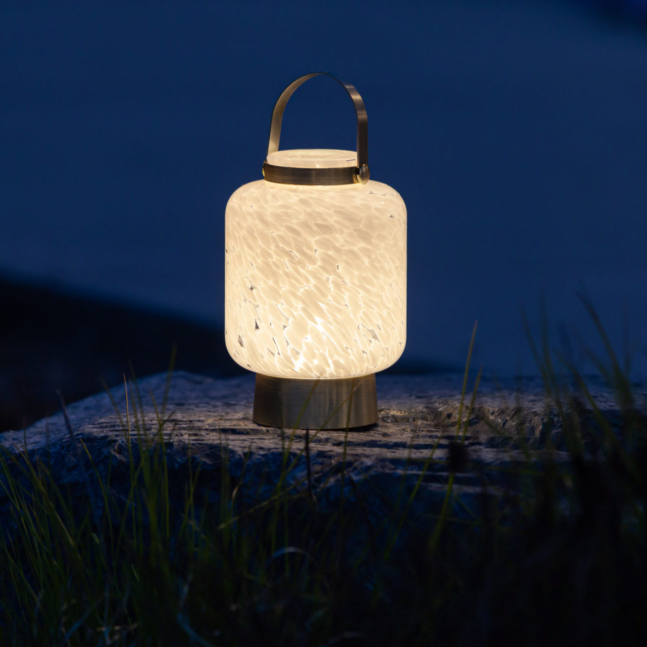 Rechargeable glass LED lanterns from LightKeeper by Allsop Home & Garden, showcasing their transparent design and built-in handle.