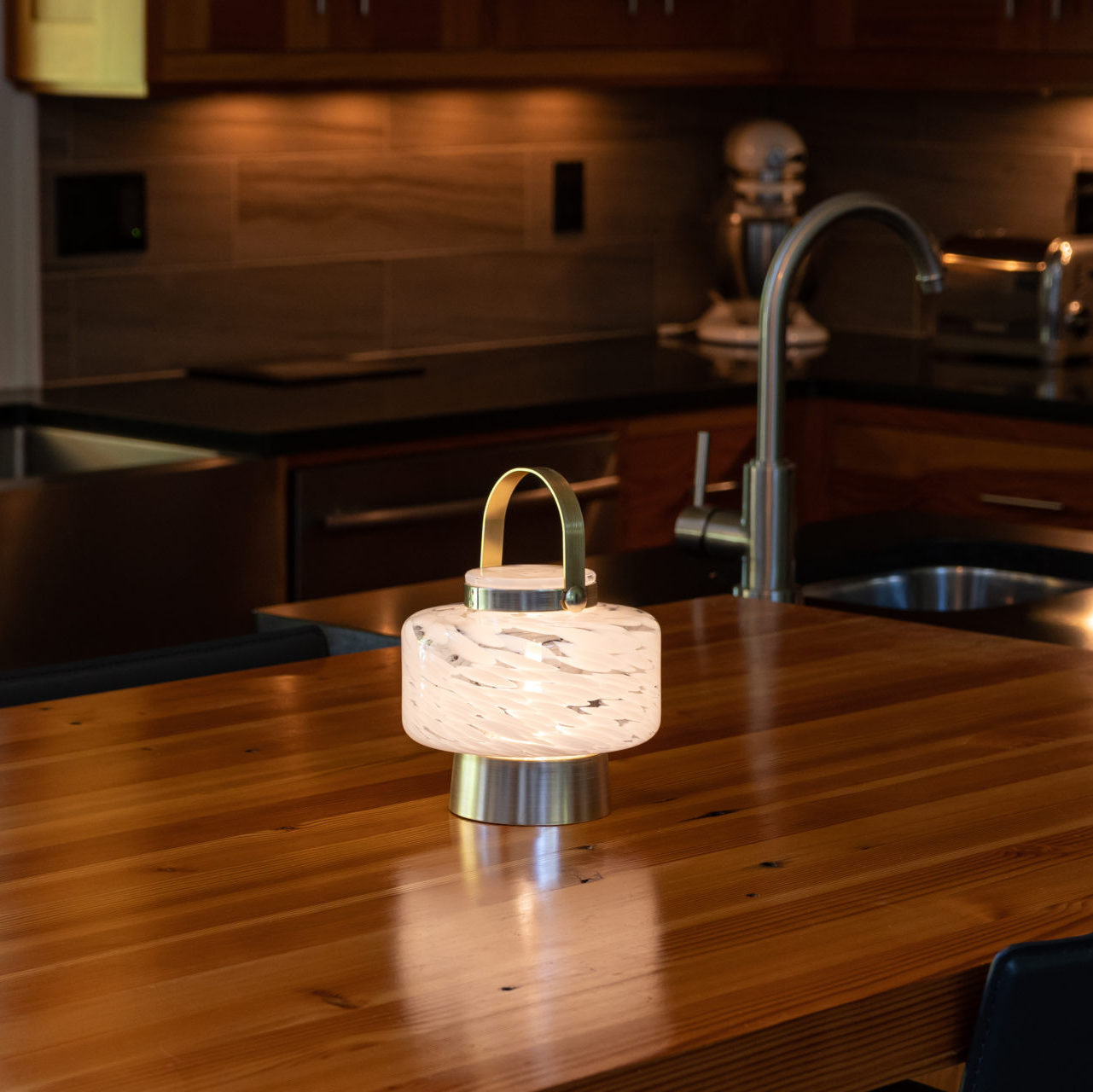 Allsop Home & Garden LightKeeper rechargeable glass LED lanterns with cone-shaped design and ambient lighting.