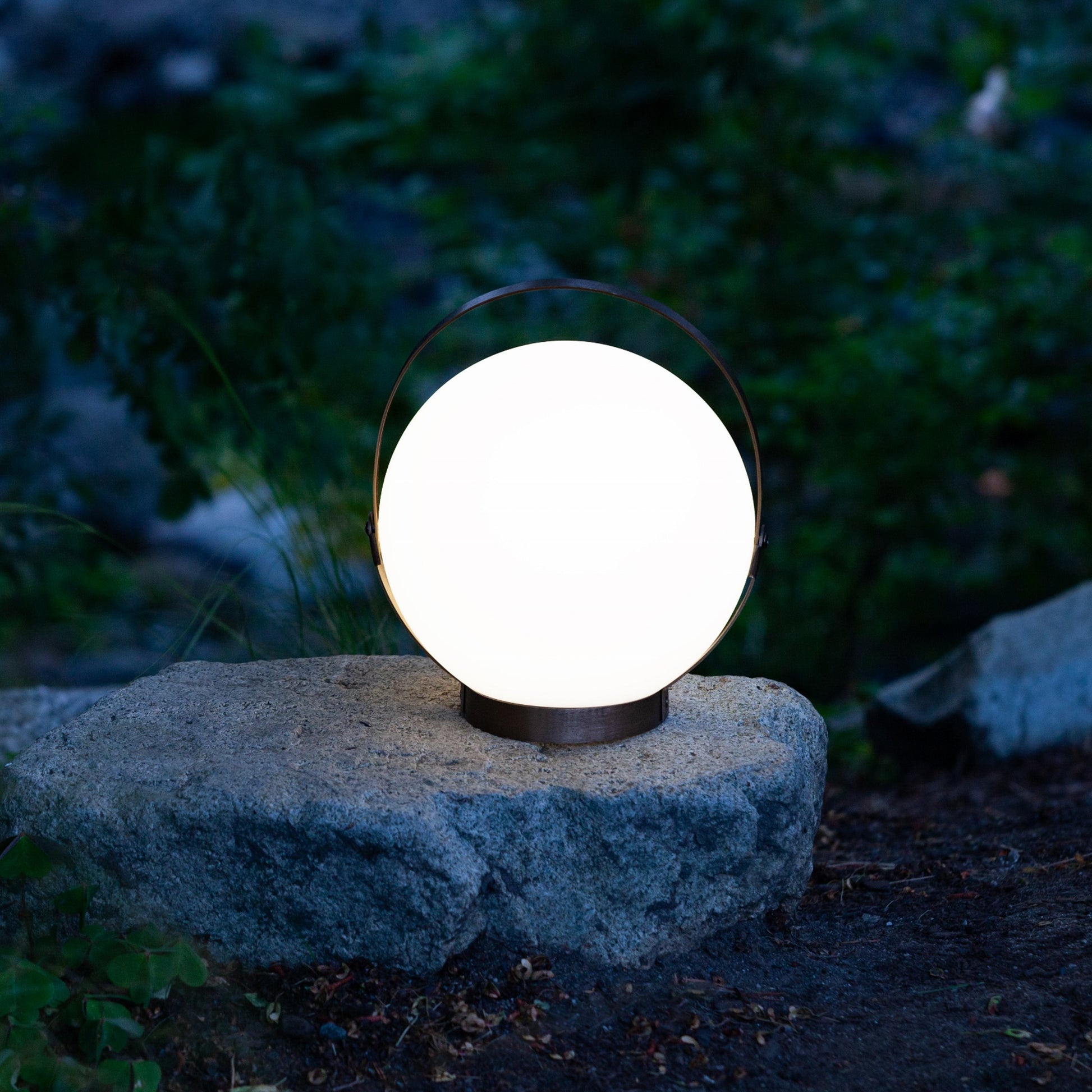 Allsop Home & Garden Moonrise portable rechargeable LED lantern emitting bright light, designed for outdoor and camping use.