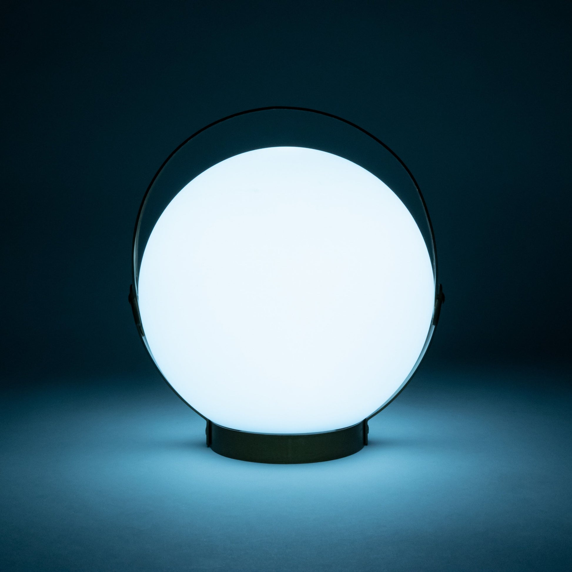 Allsop Home & Garden Moonrise portable rechargeable LED lantern with handle, glowing softly in a dark setting.