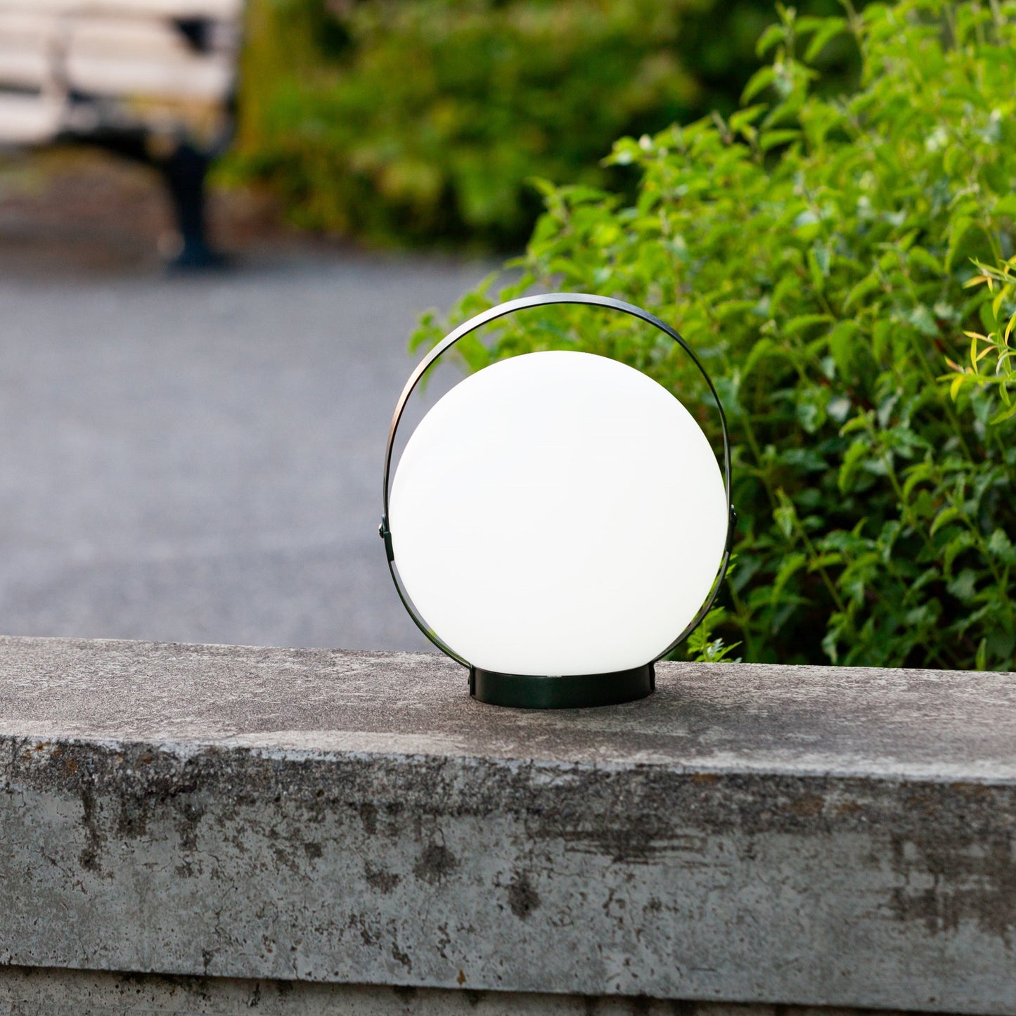 Allsop Home & Garden Moonrise portable rechargeable LED lantern glowing with bright light, designed for outdoor or emergency use.