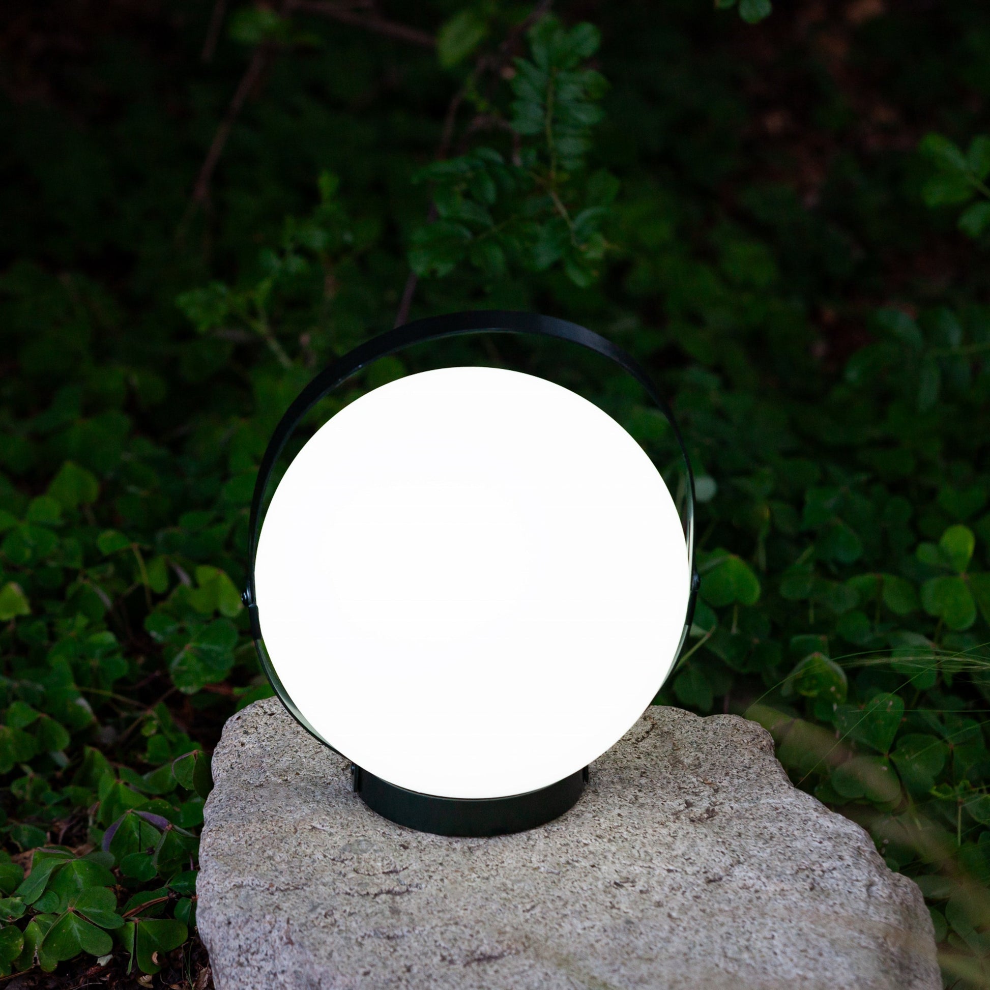 Allsop Home & Garden Moonrise portable rechargeable LED lantern showing a compact, outdoor-ready lantern with a handle and illuminated light.
