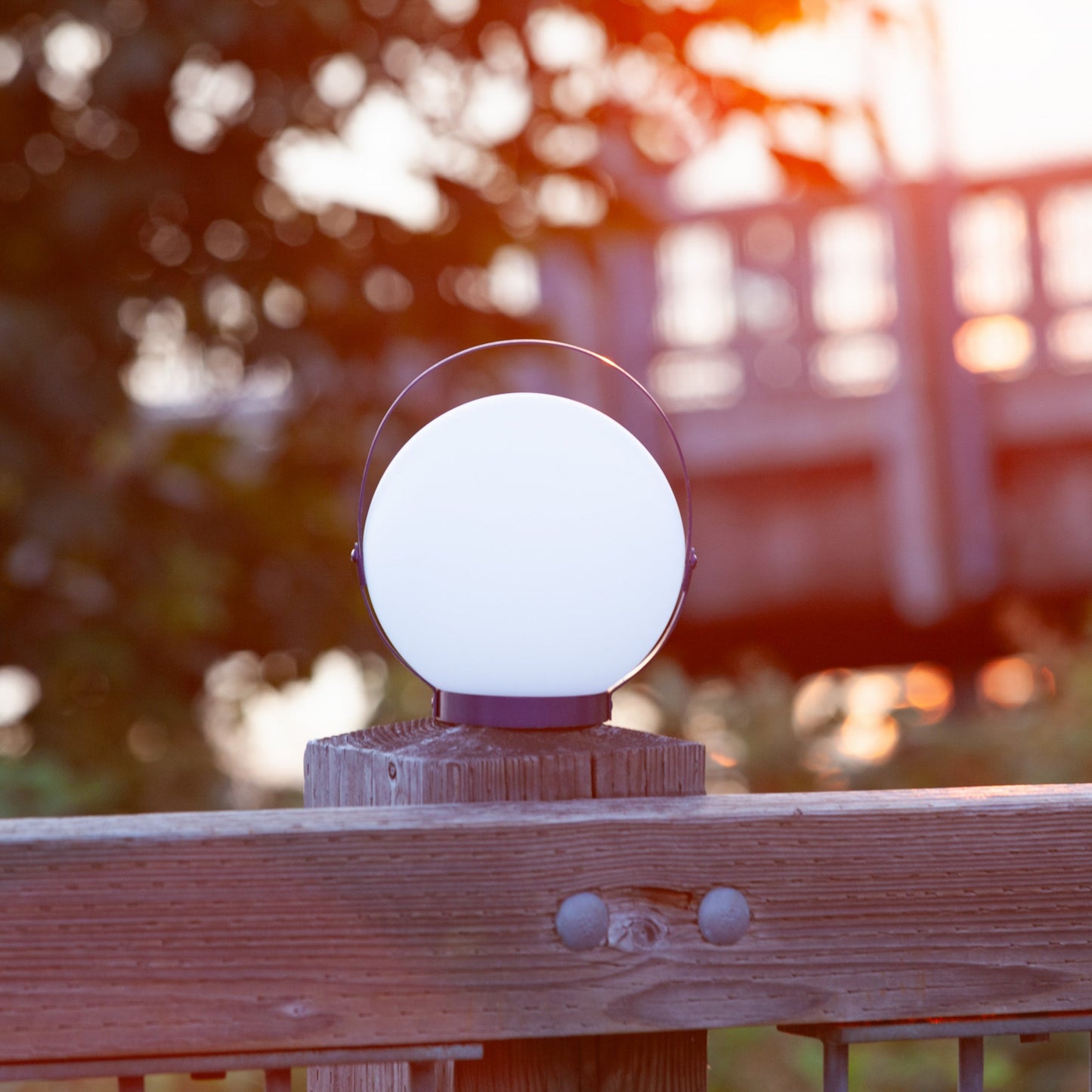 Allsop Home & Garden Moonrise portable rechargeable LED lantern with handle, emitting bright light in a compact design.