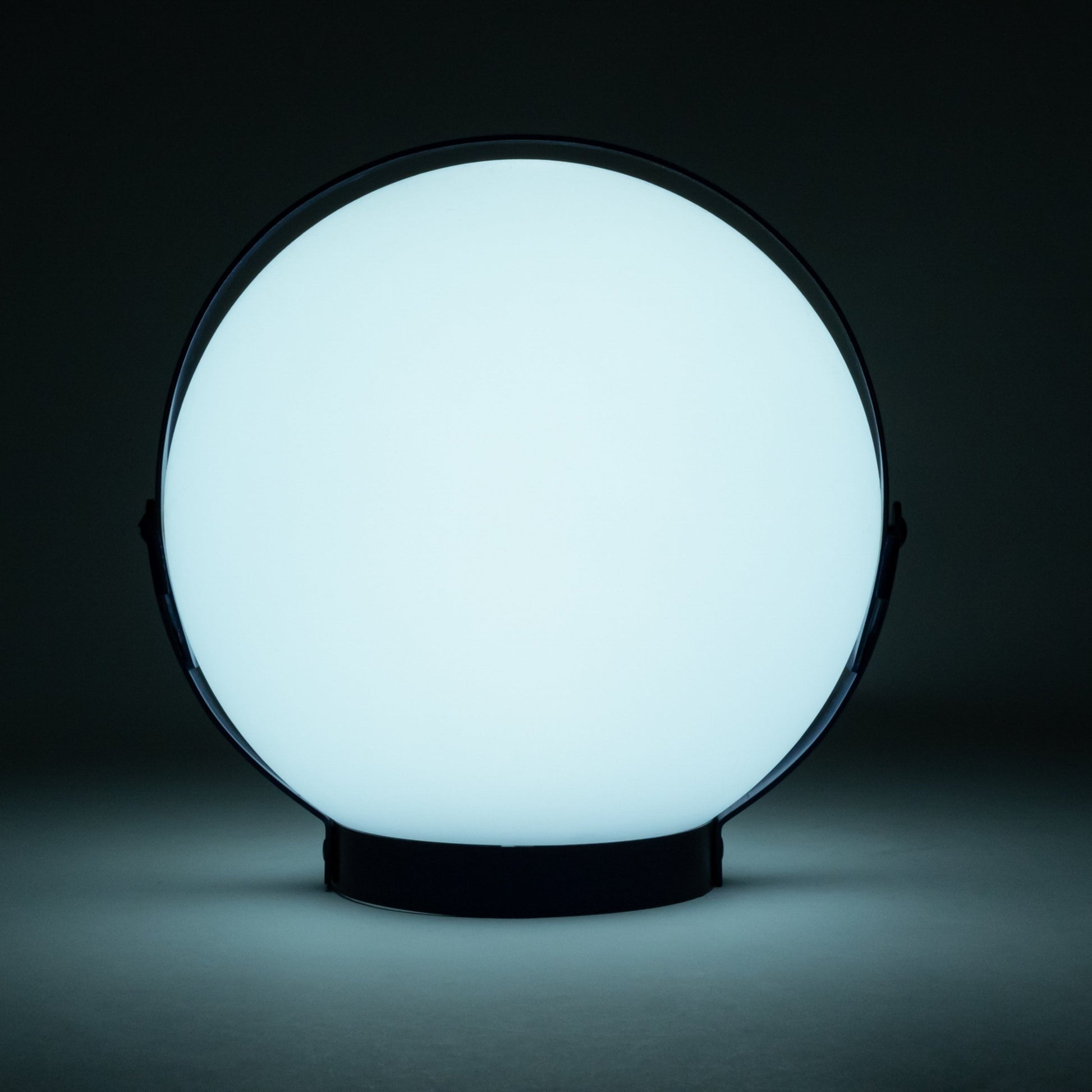 Allsop Home & Garden Moonrise portable rechargeable LED lantern illuminated, showcasing its compact design and built-in handle.