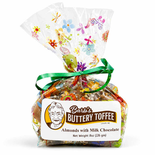Homemade milk chocolate toffee with almonds, buttery texture, and nut options, displayed in an 8 oz package from Barb's Buttery Toffee.