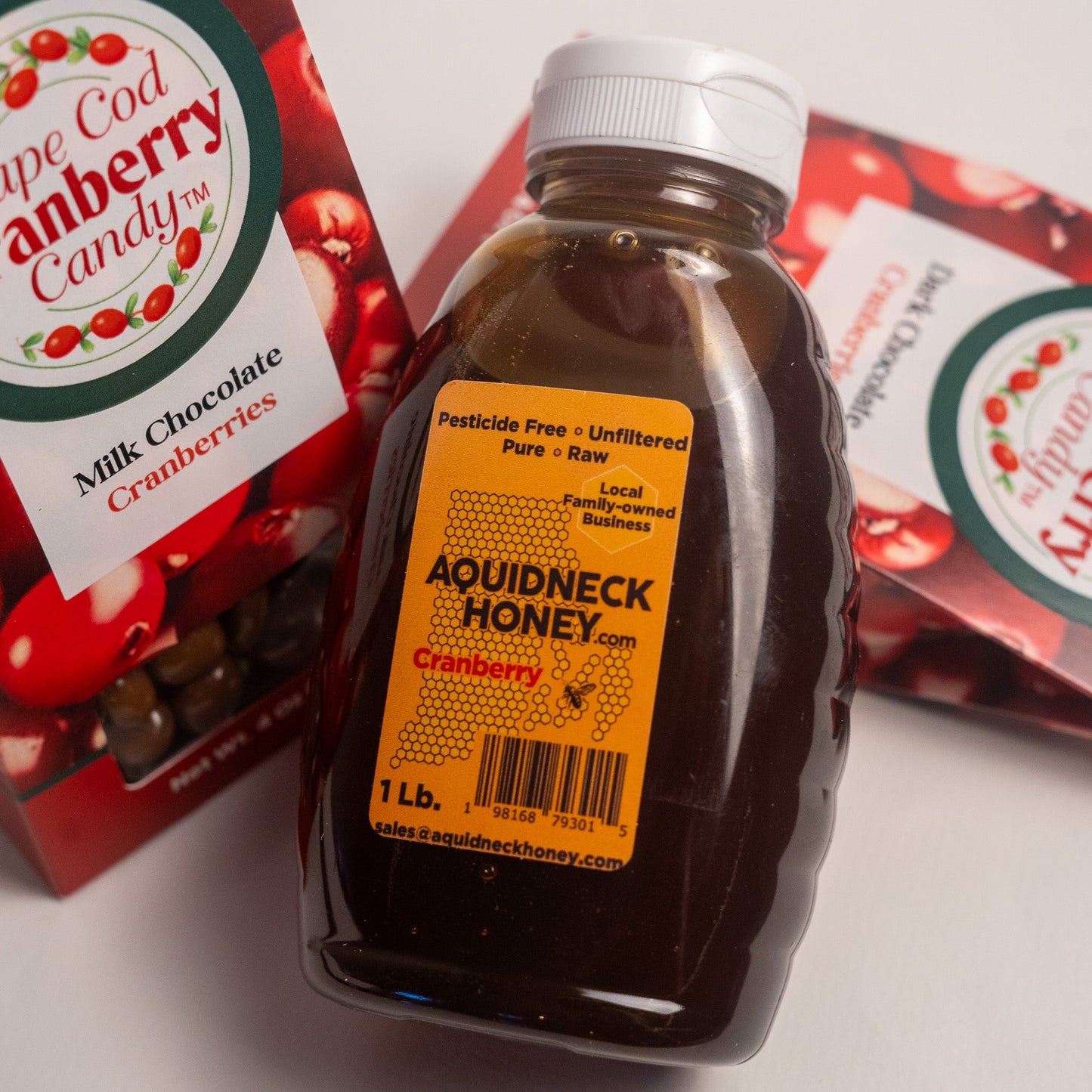 Aquidneck Honey Cranberry Honey and Chocolate Gift Box with jars of honey, cranberry spread, and chocolates arranged attractively.