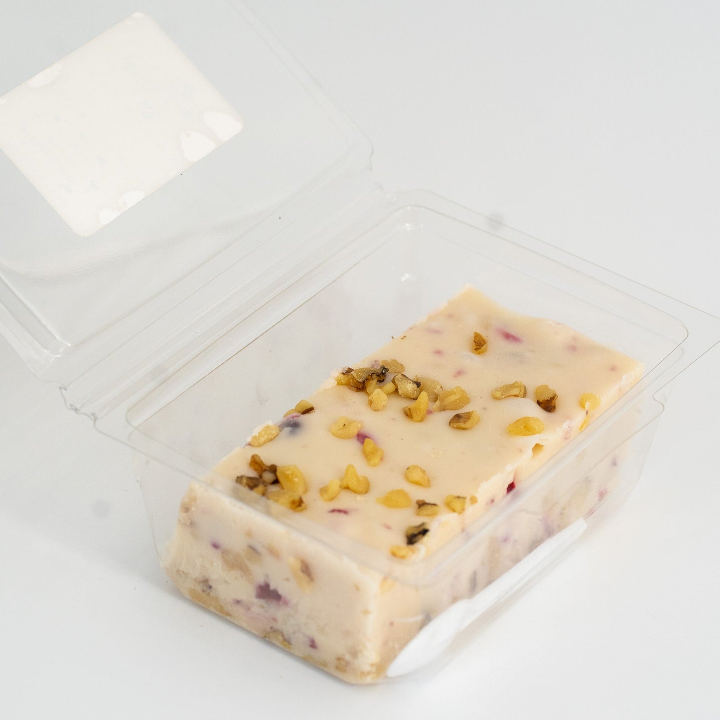 Cranberry Walnut Honey Fudge by Aquidneck Honey showing a square piece with cranberries and walnuts on top