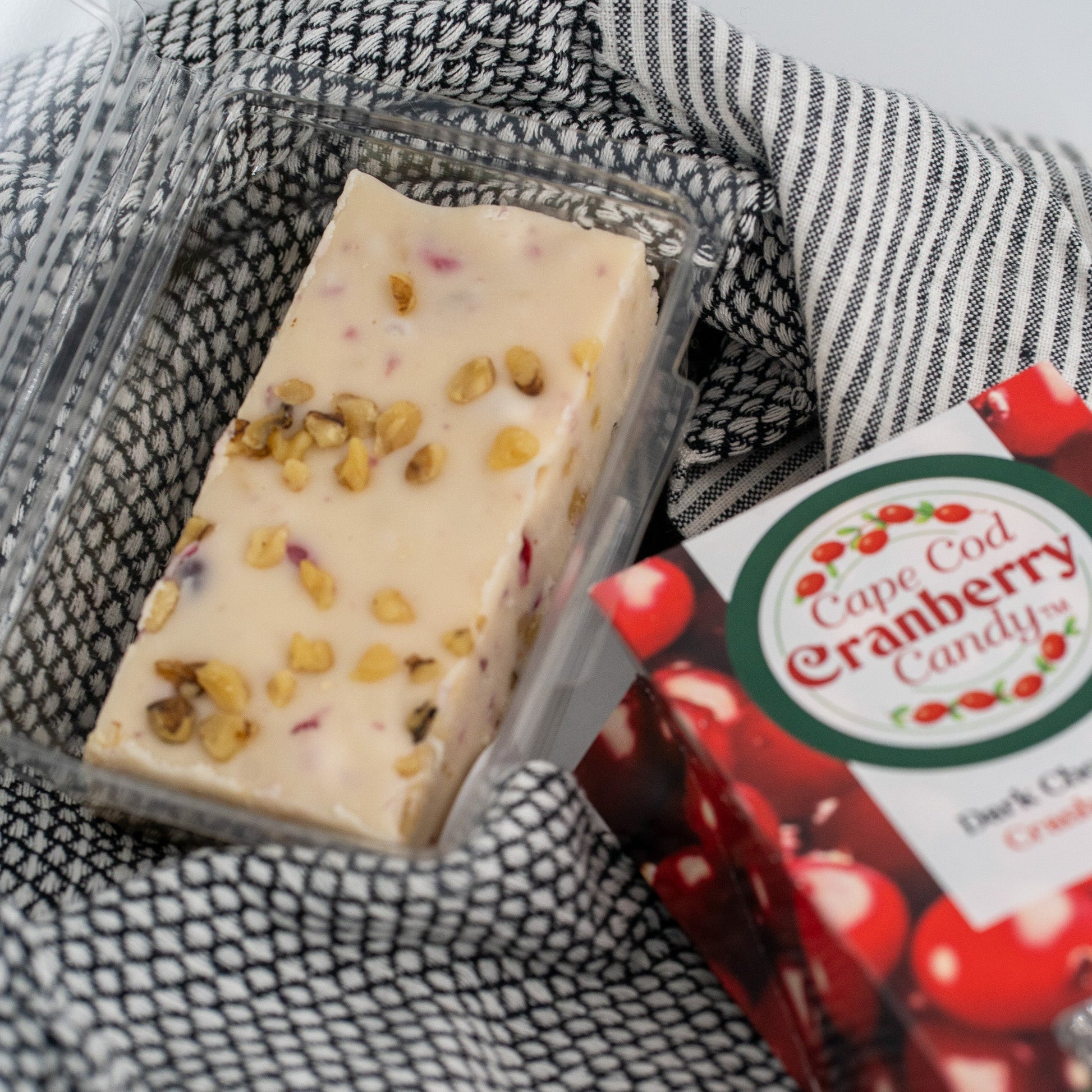 Cranberry Walnut Honey Fudge by Aquidneck Honey showing rich, smooth fudge with visible cranberries and walnuts on top.