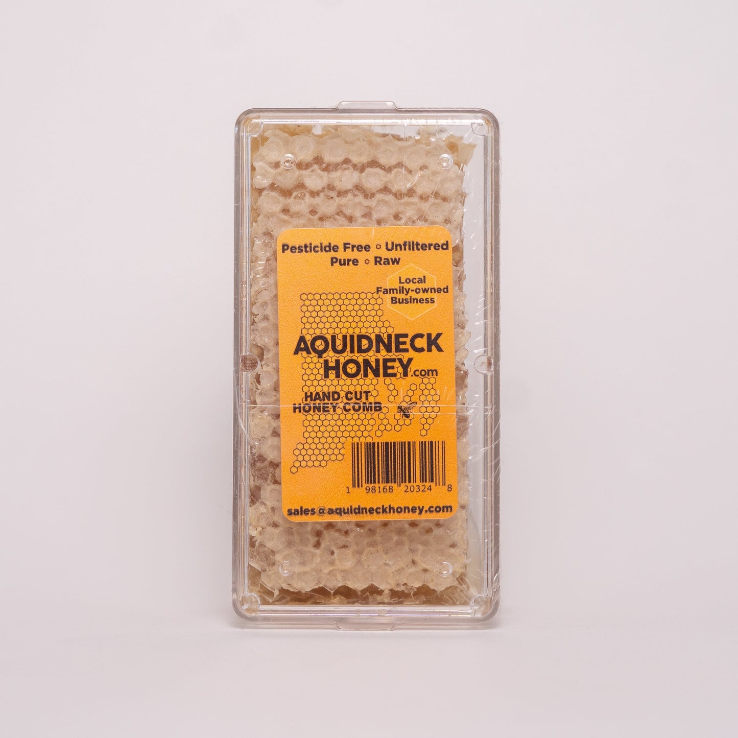 Aquidneck Honey New England hand-cut honey comb showcasing golden honey-filled beeswax with natural texture and hexagonal pattern.