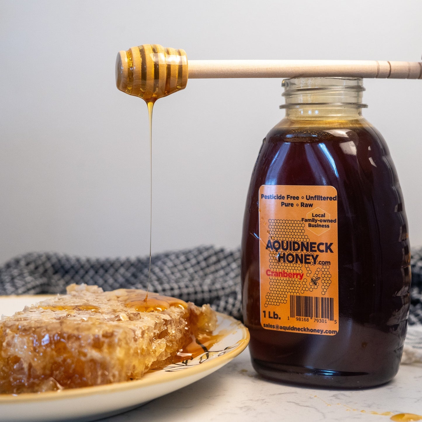 A small piece of New England hand-cut honeycomb from Aquidneck Honey showing golden honey and natural beeswax.