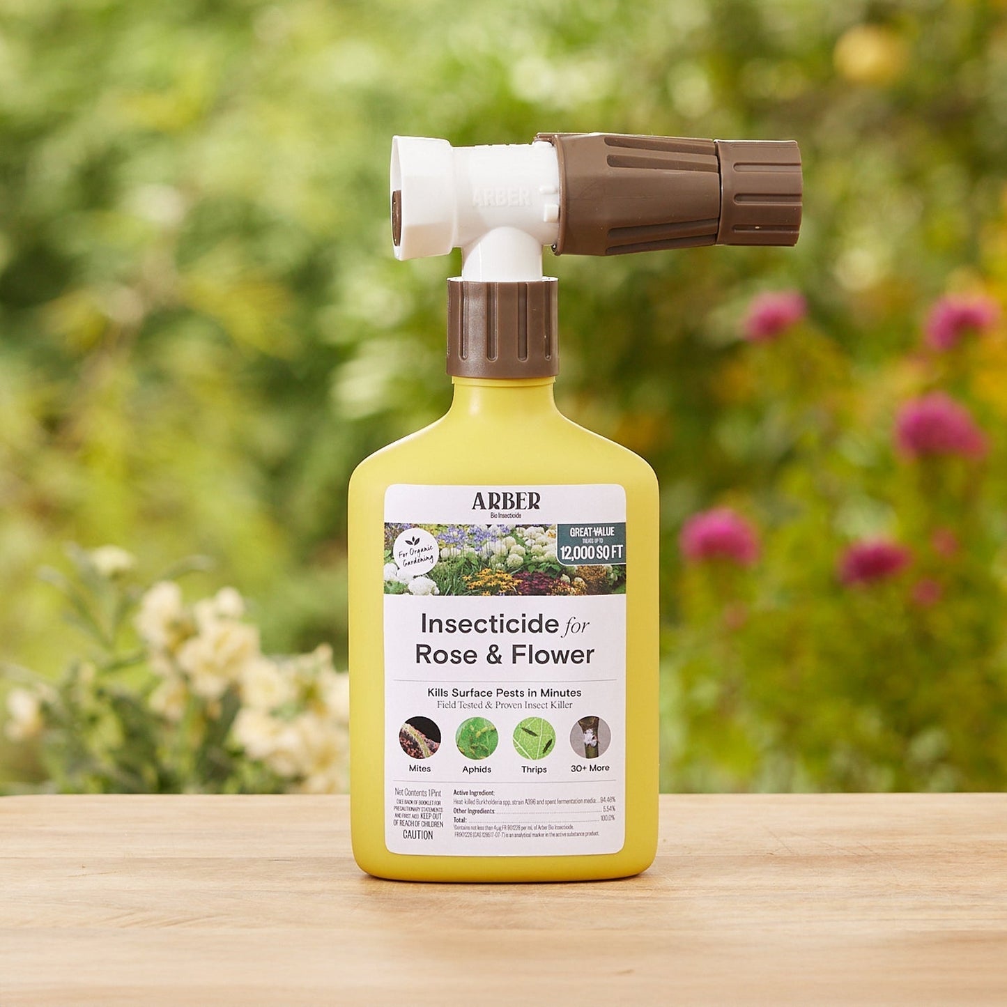 Organic insecticide for roses and flowers by Arber, featuring a spray bottle and blooming garden roses.