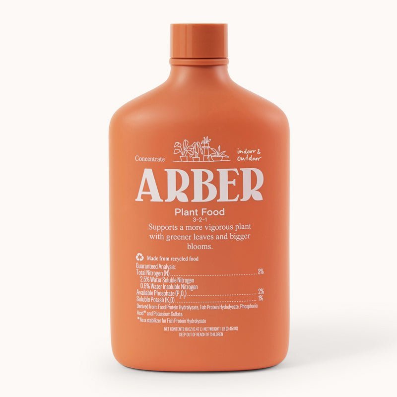 Organic plant food by Arber, showing a bag of natural fertilizer with fresh green plants in the background