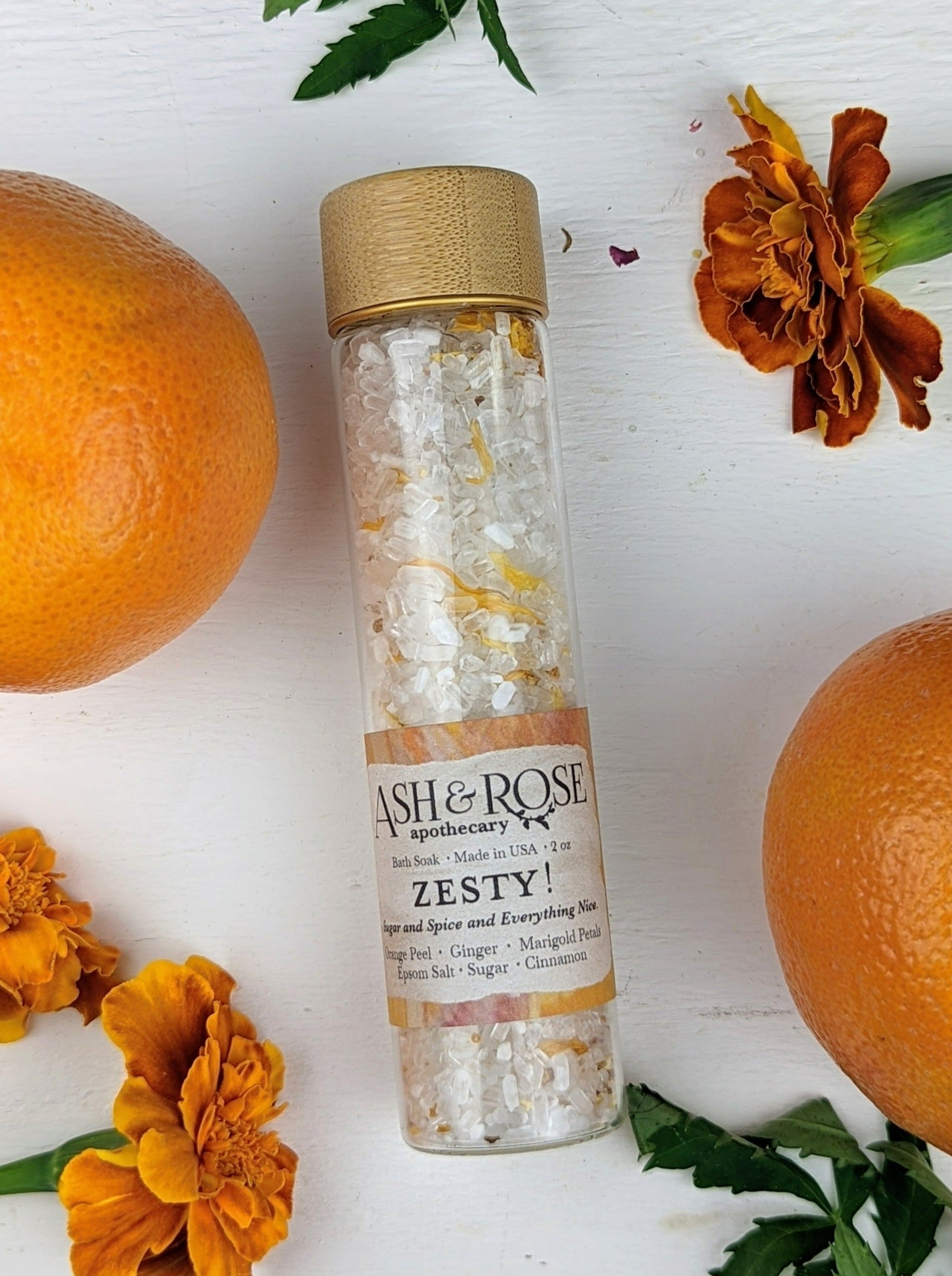 Ash & Rose ZESTY! Orange Ginger bath soak vial with vibrant orange liquid and a natural, aromatic appearance.