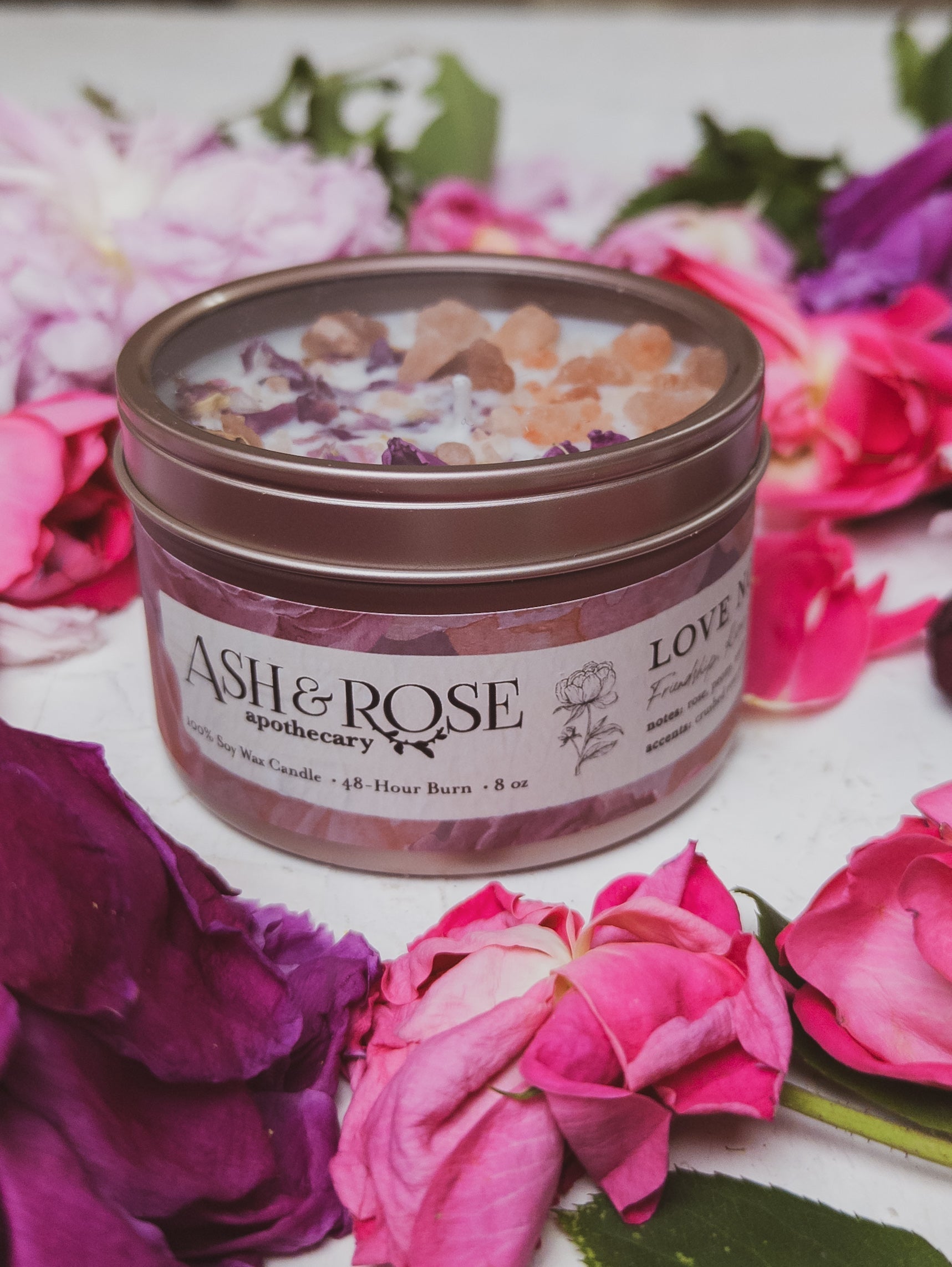 Ash & Rose LOVE NOTES Rose and Pink Salt Candle, 4 oz, with a white ceramic container and a lit wick.