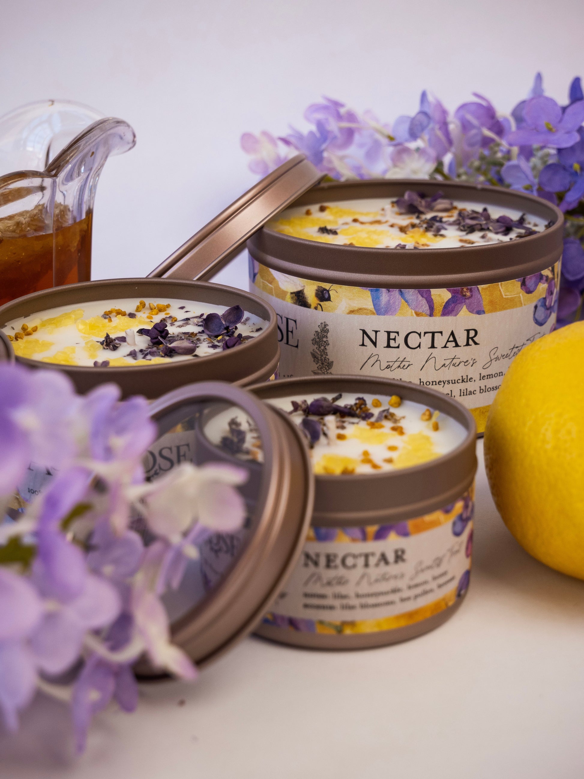 Ash & Rose Nectar Lilac Lemon Honey candle, 4 oz, with a lilac and lemon scent, featuring a decorative wax candle in a glass jar.