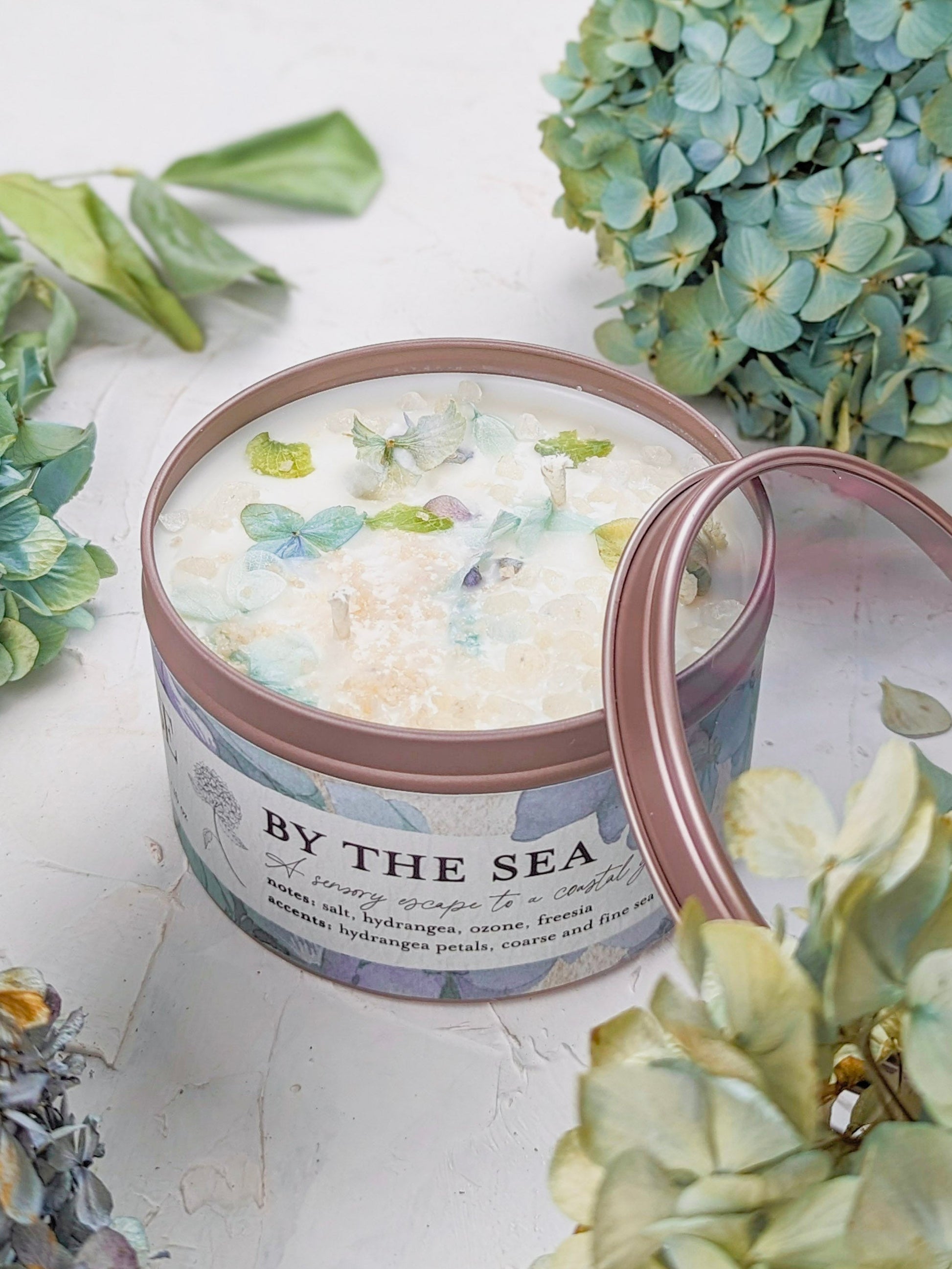 Ash & Rose BY THE SEA Hydrangea Sea Salt Candle, 4 oz, featuring a white candle with hydrangea and sea salt scent elements.