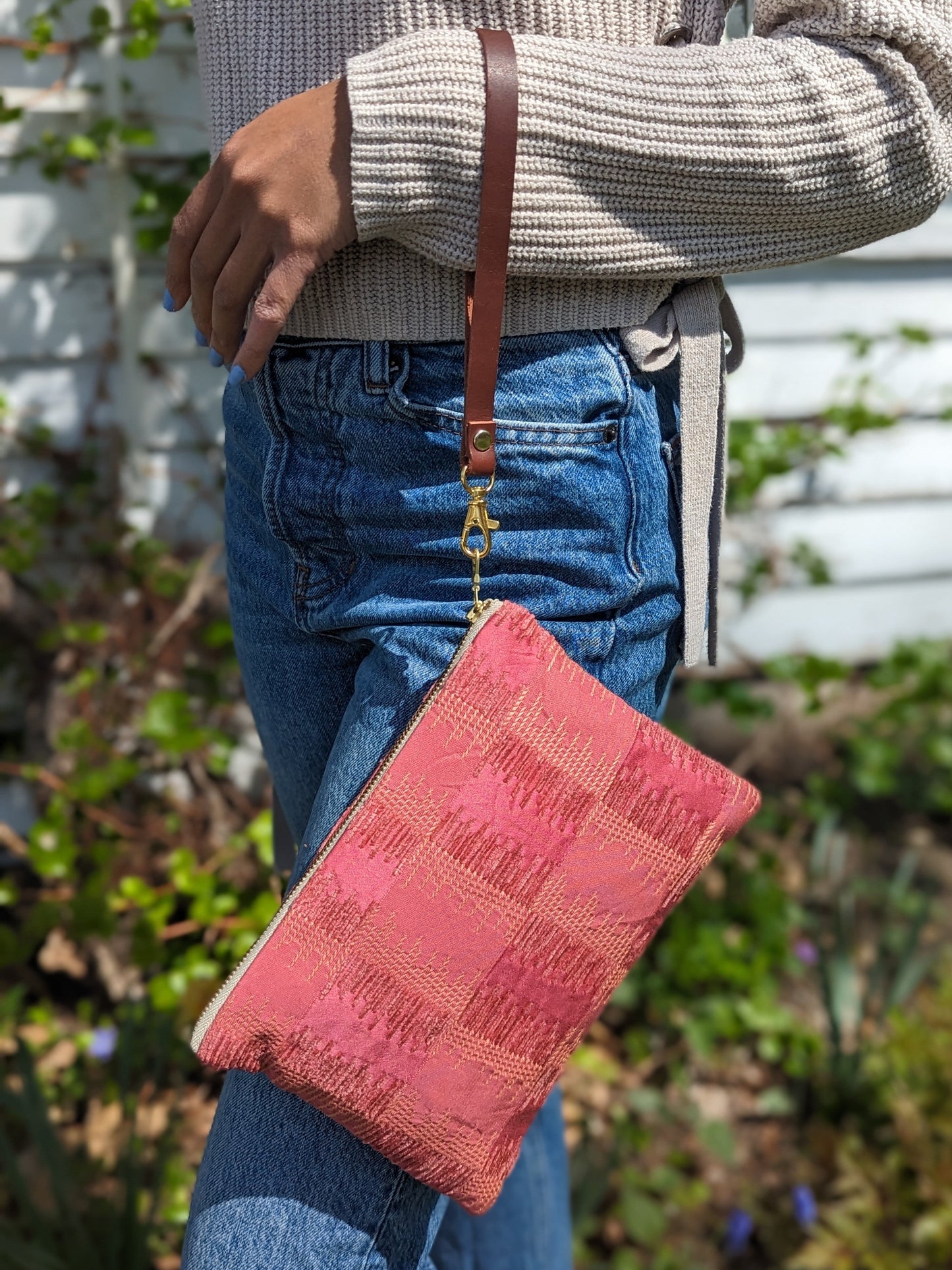Ash & Rose Shades of Apricot wristlet purse with a sleek design, featuring a zipper closure and compact size for easy carrying.
