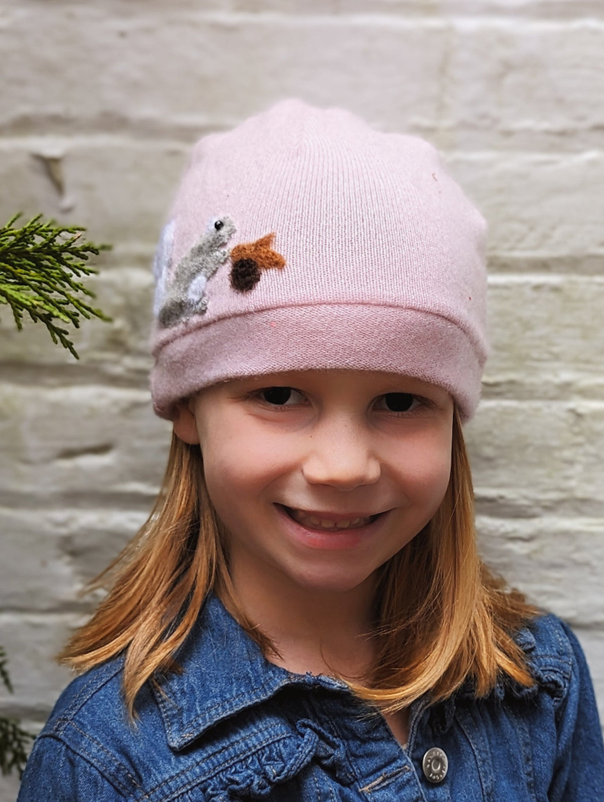 Child's orange cashmere squirrel hat by Ash & Rose with cute squirrel design and cozy knit fabric.