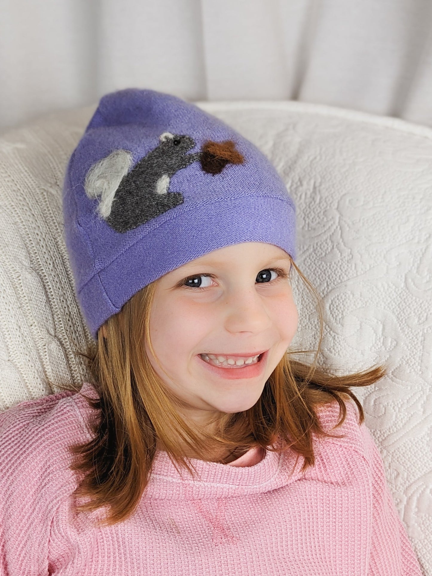 Child's orange cashmere squirrel hat by Ash & Rose with cute squirrel design and cozy knit texture.