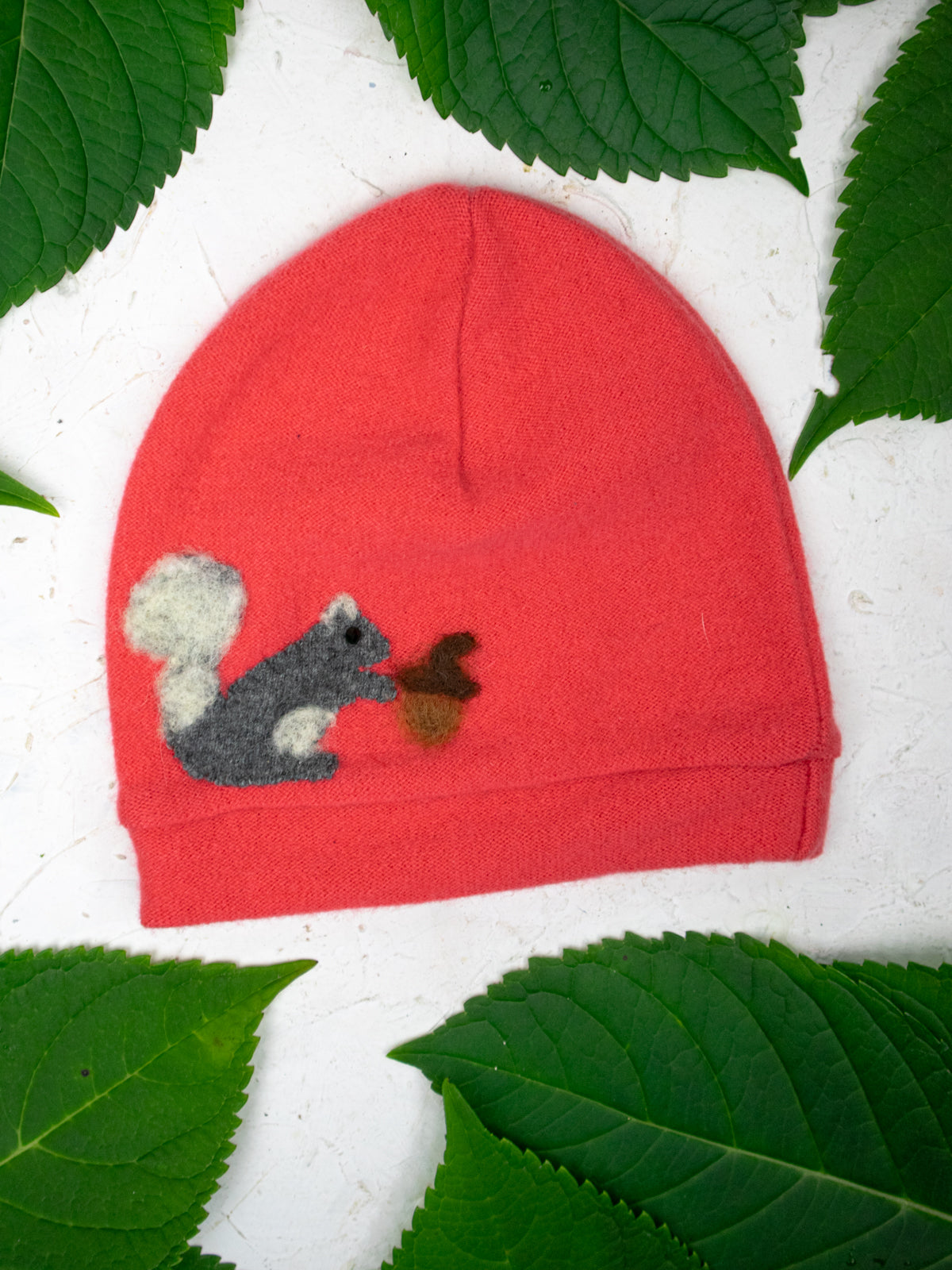 Child's orange cashmere squirrel hat by Ash & Rose featuring a cozy, knit design with cute squirrel details.