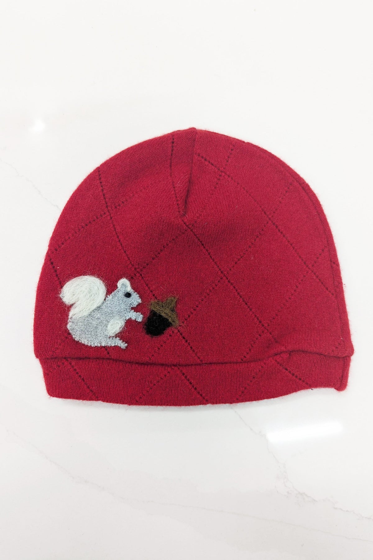 Child's orange cashmere squirrel hat by Ash & Rose featuring a cute squirrel design and cozy knit texture.