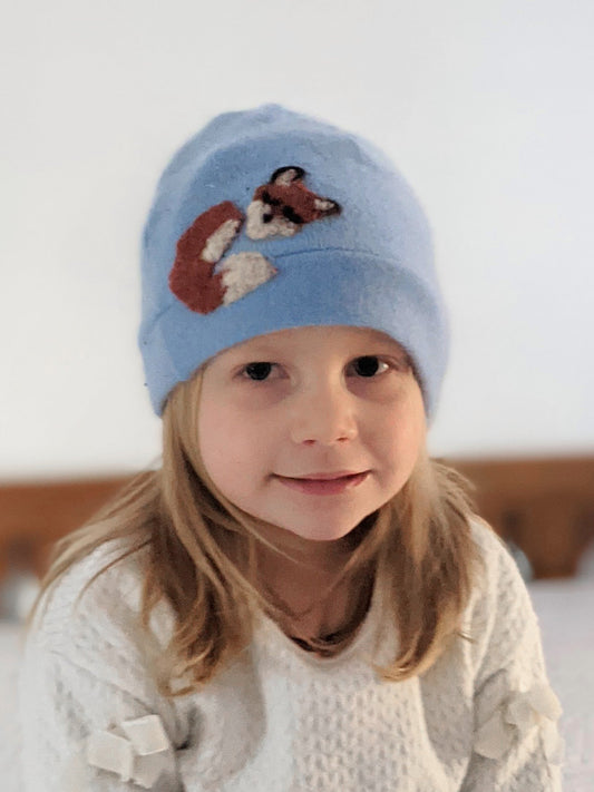 Child's Ash & Rose Sleeping Fox Cashmere Hat in sky blue, soft knit hat with fox design, cozy and stylish for kids.