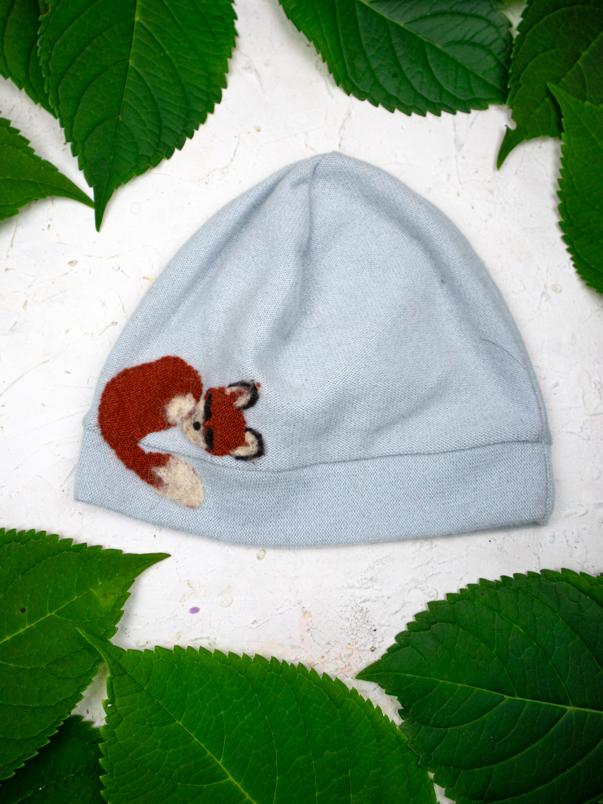 Child's Ash & Rose Sleeping Fox Cashmere Hat in sky blue, soft knit with fox design, cozy and stylish for cold weather.